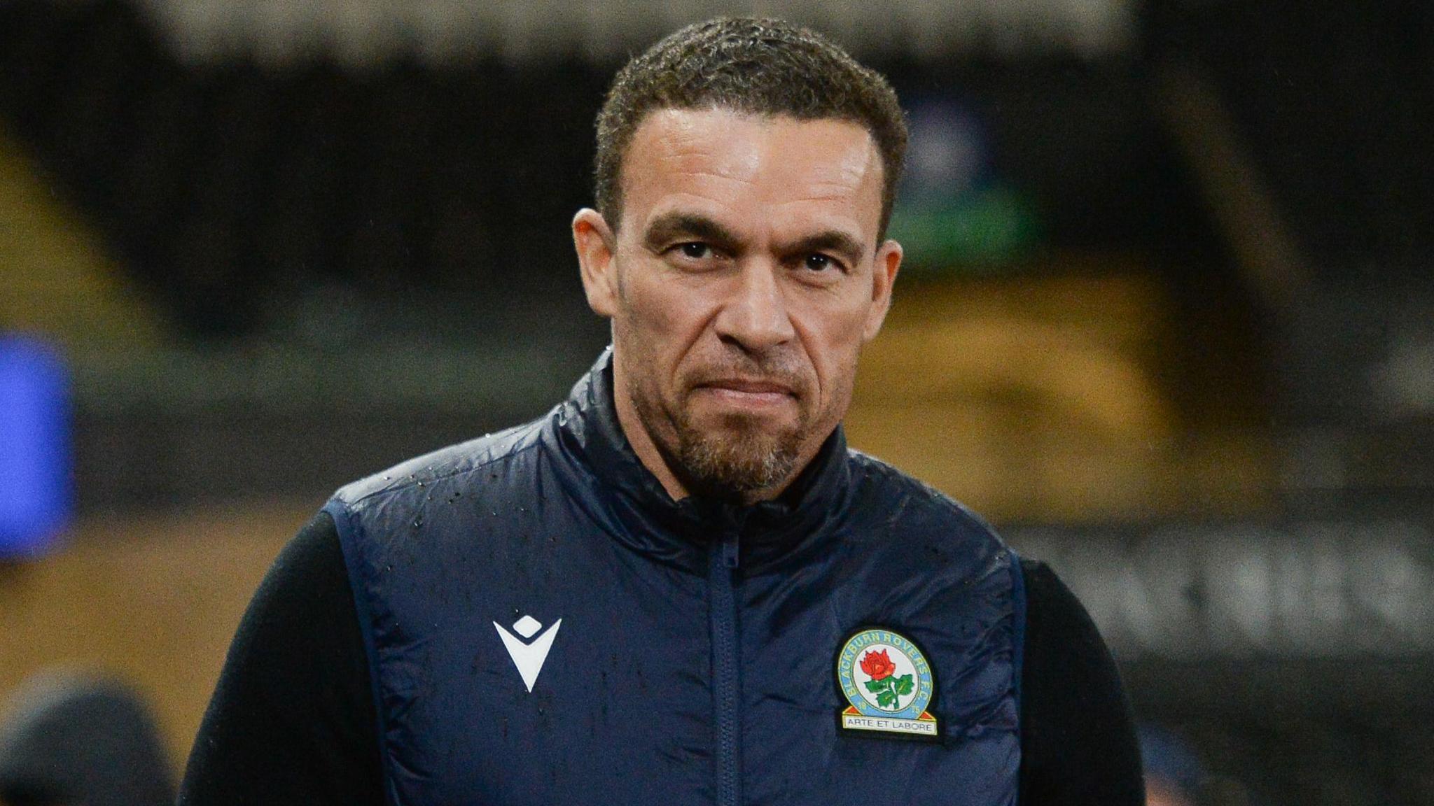 Valerien Ismael, wearing a navy blue jacket with a Blackburn logo on the left of the chest, looks straight-faced while arriving at the Swansea.com stadium before a game in January