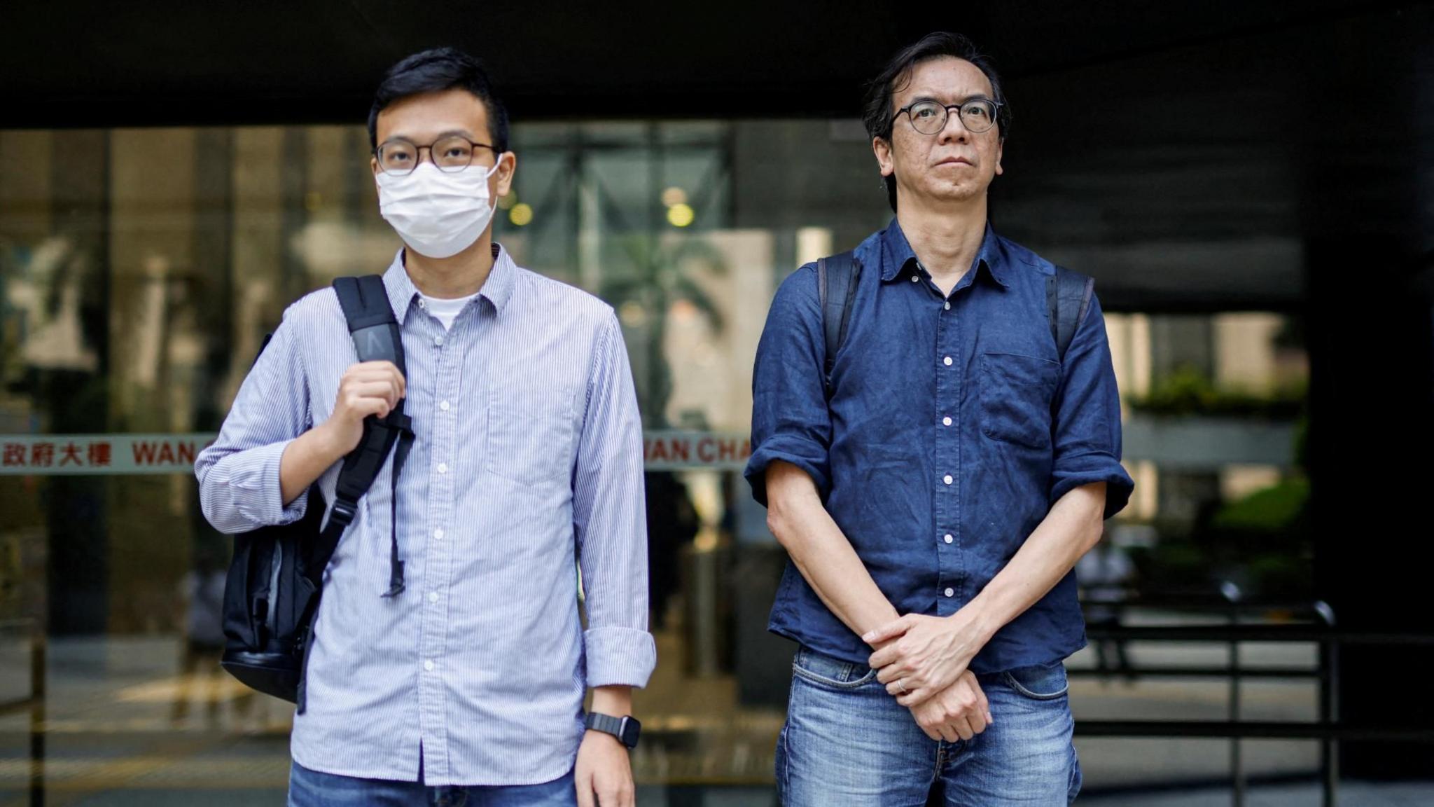 Chung Pui-kuen and Patrick Lam outside a courthouse in Hong. Both are wearing glasses and Pui-kuen is wearing a facemask.