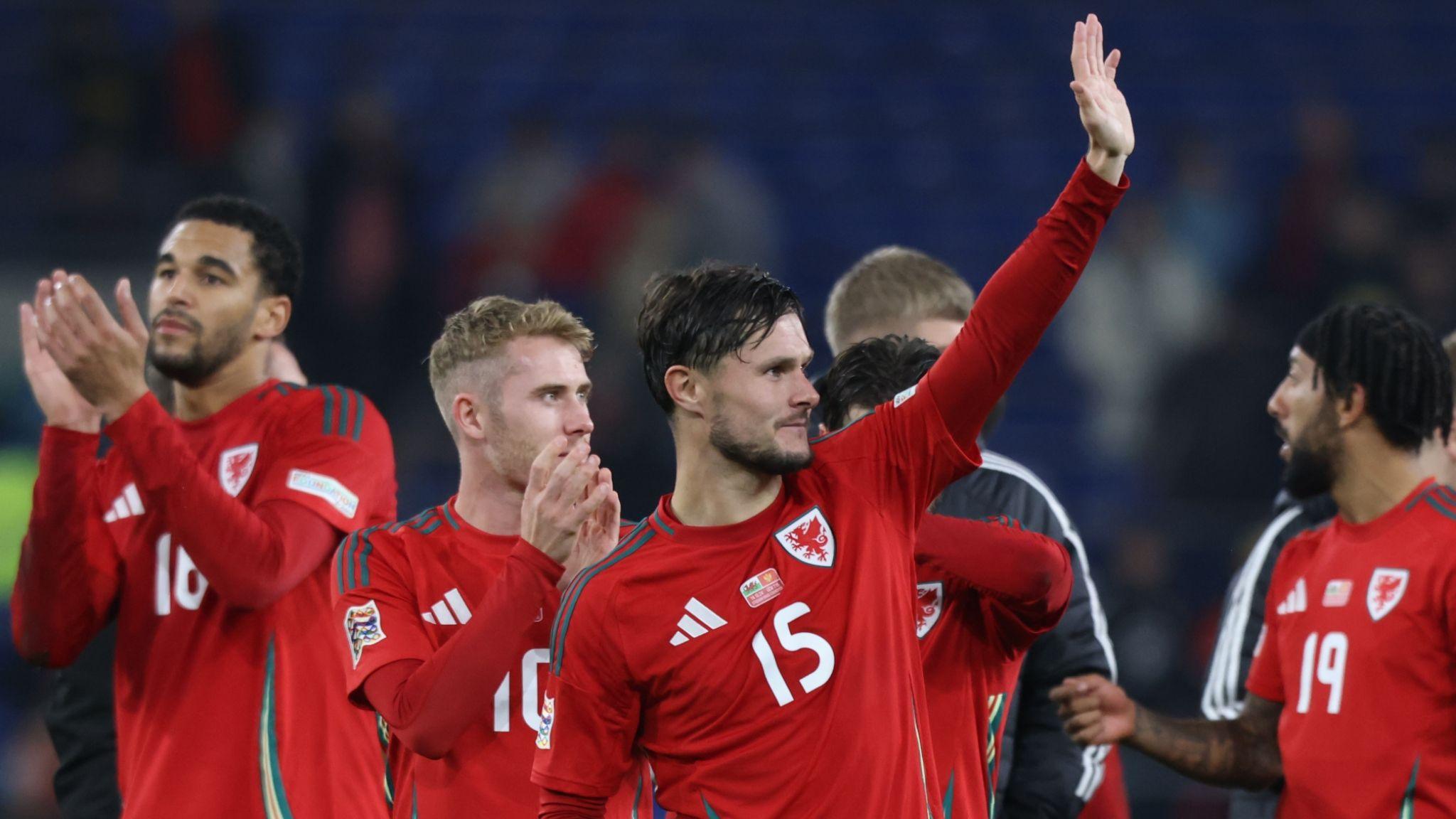 Wales players applaud fans after a game