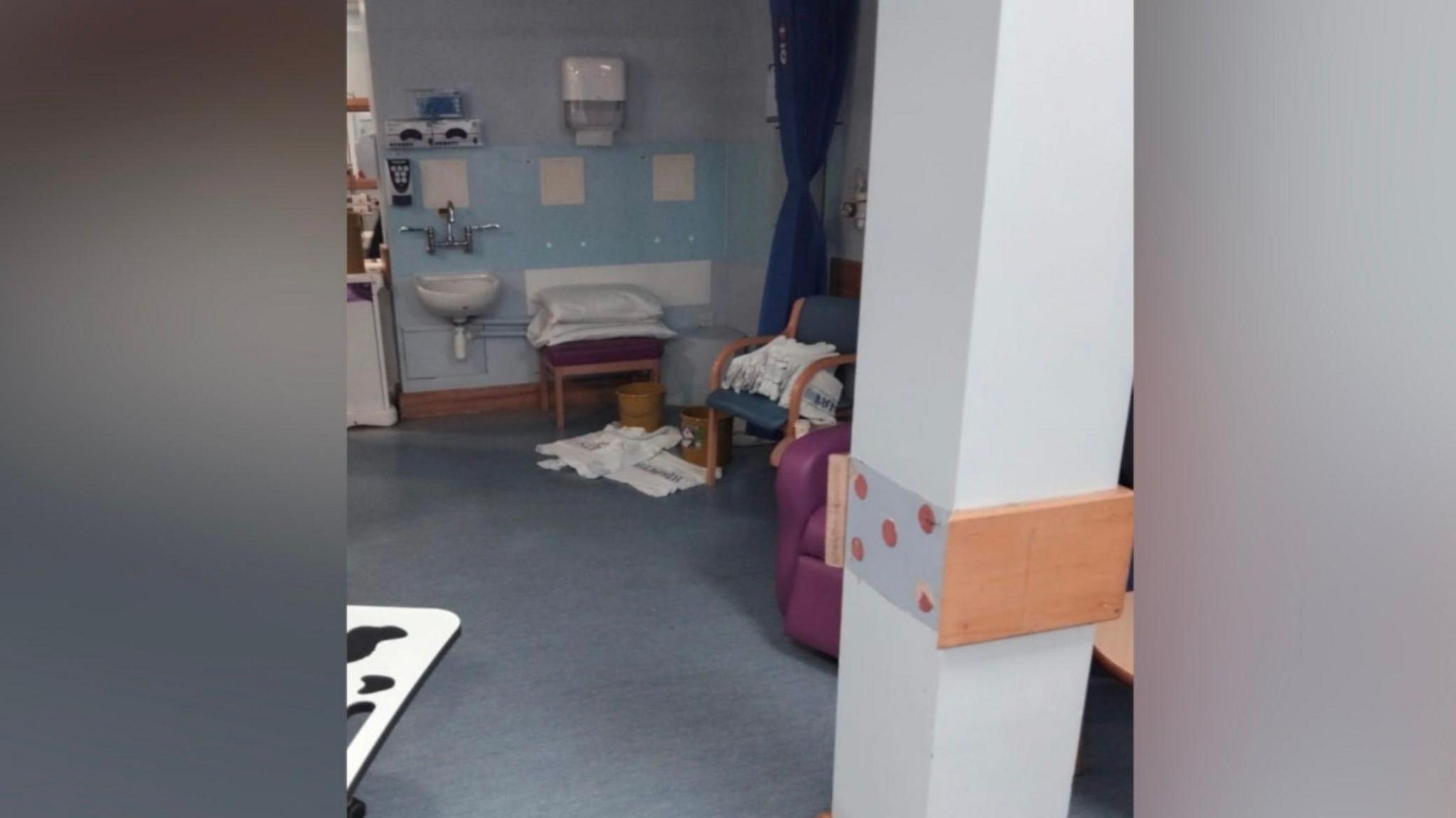 Towels cover a patient chair and some towels cover part of the floor in a patient area of the cancer unit at the Royal Sussex County Hospital.