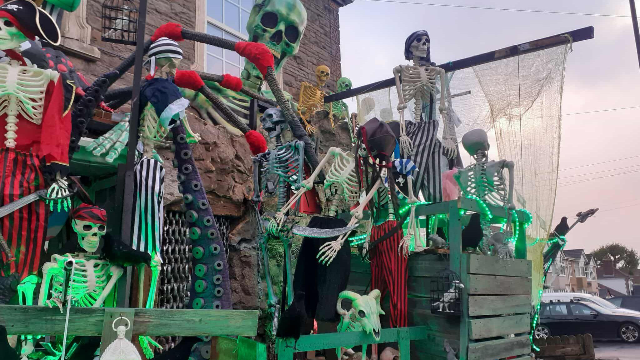 A Halloween display outside a house. The display includes skeletons dressed as pirates, a giant octopus and the rigging of a ship.