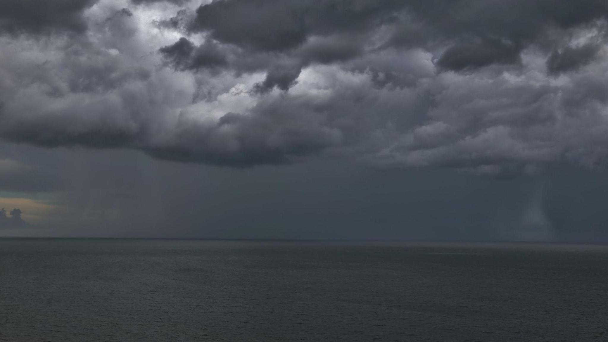 dark storm clouds over an ocean.