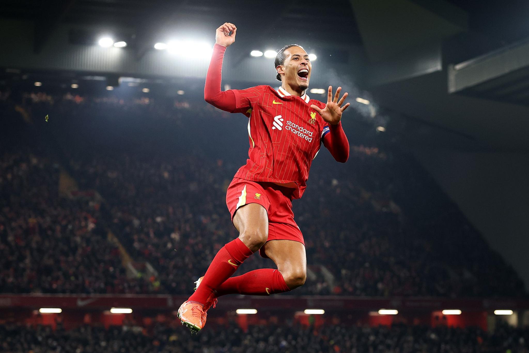 Virgil van Dijk celebrates scoring his team's fourth goal during the Carabao Cup Semi Final Second Leg match between Liverpool and Tottenham at Anfield