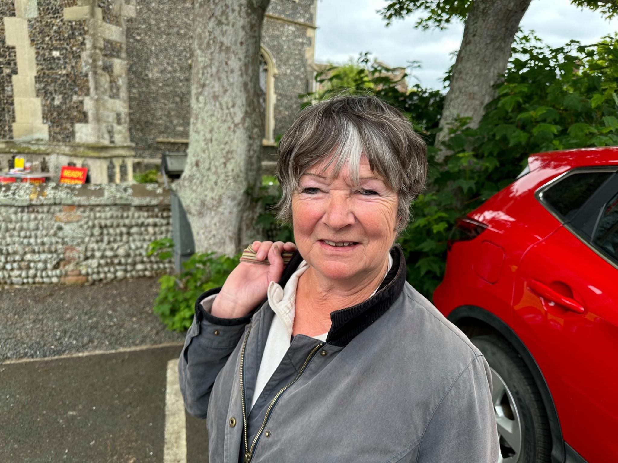 Woman standing in car park 