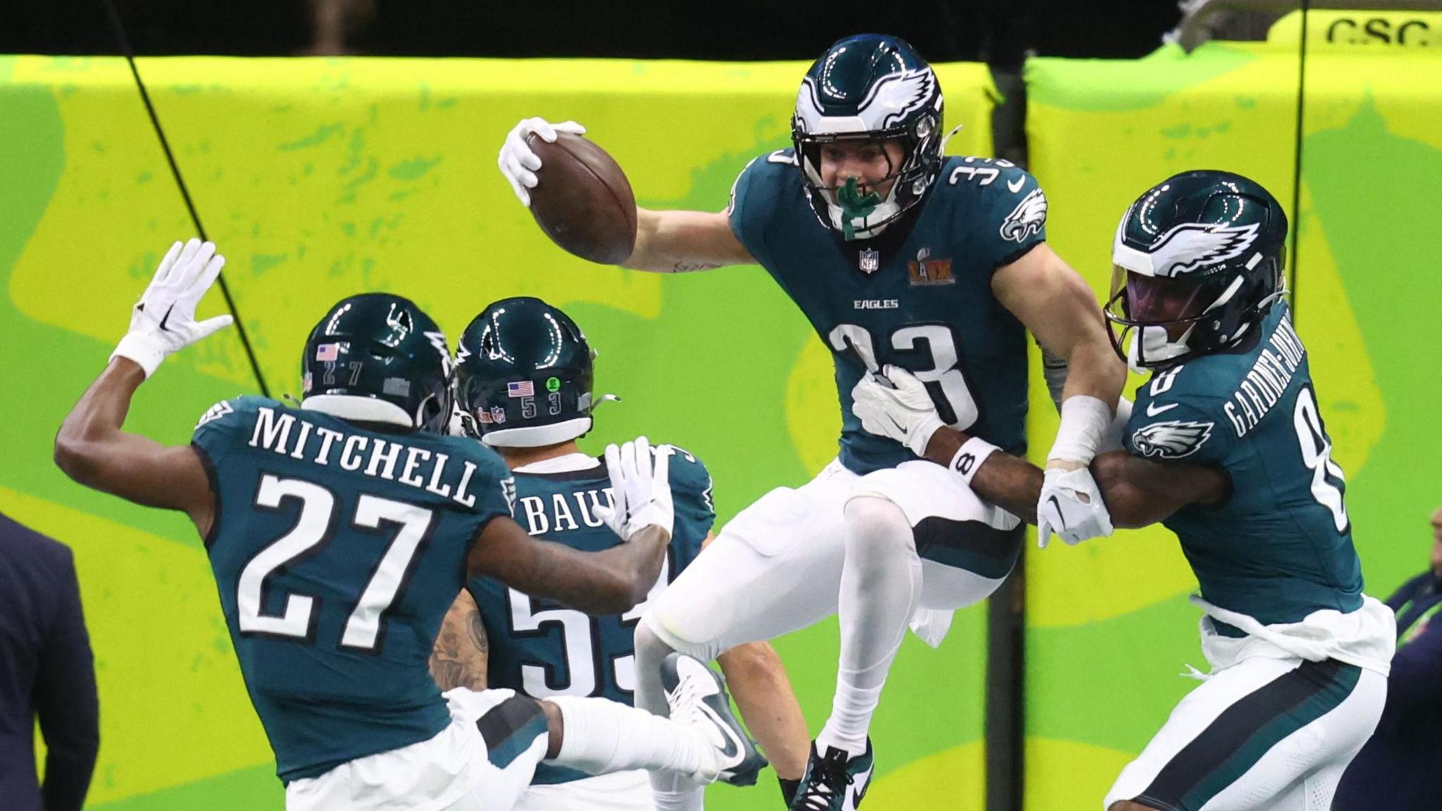 Philadelphia Eagles players celebrate a Cooper DeJean touchdown