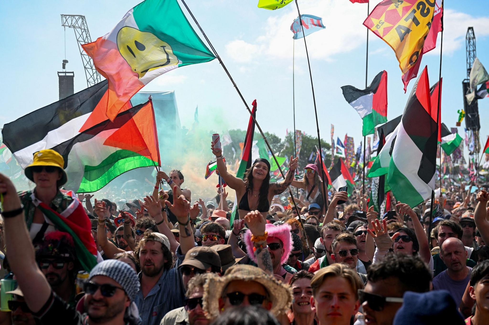 Fans watch Kneecap, while some hold Palestinian flags