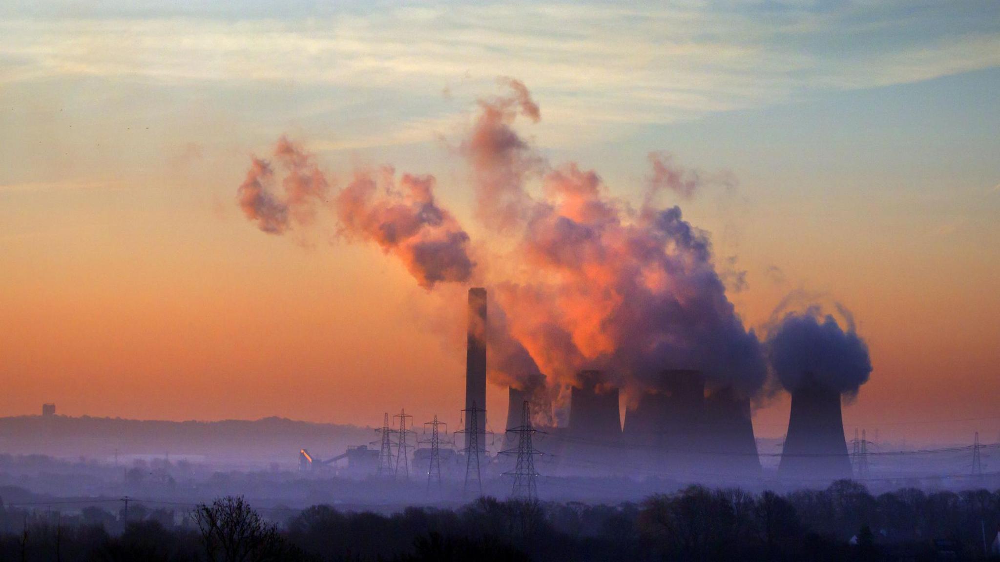 a power station emitting vapour from chimneys