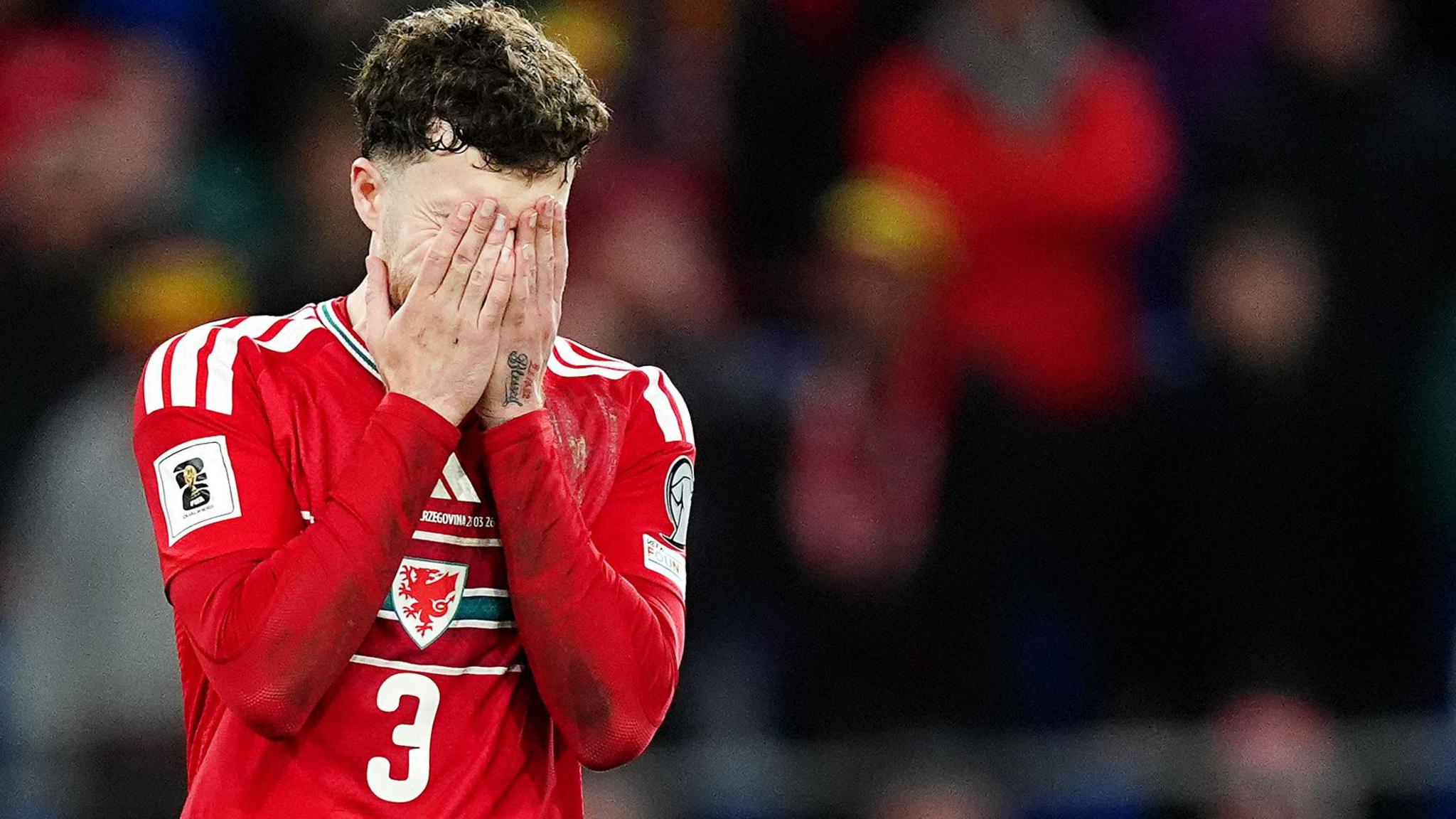 Wales' Neco Williams covers his face with his hands after missing his penalty in the shoot-out during the 2026 FIFA World Cup European Play-off Semi-final.