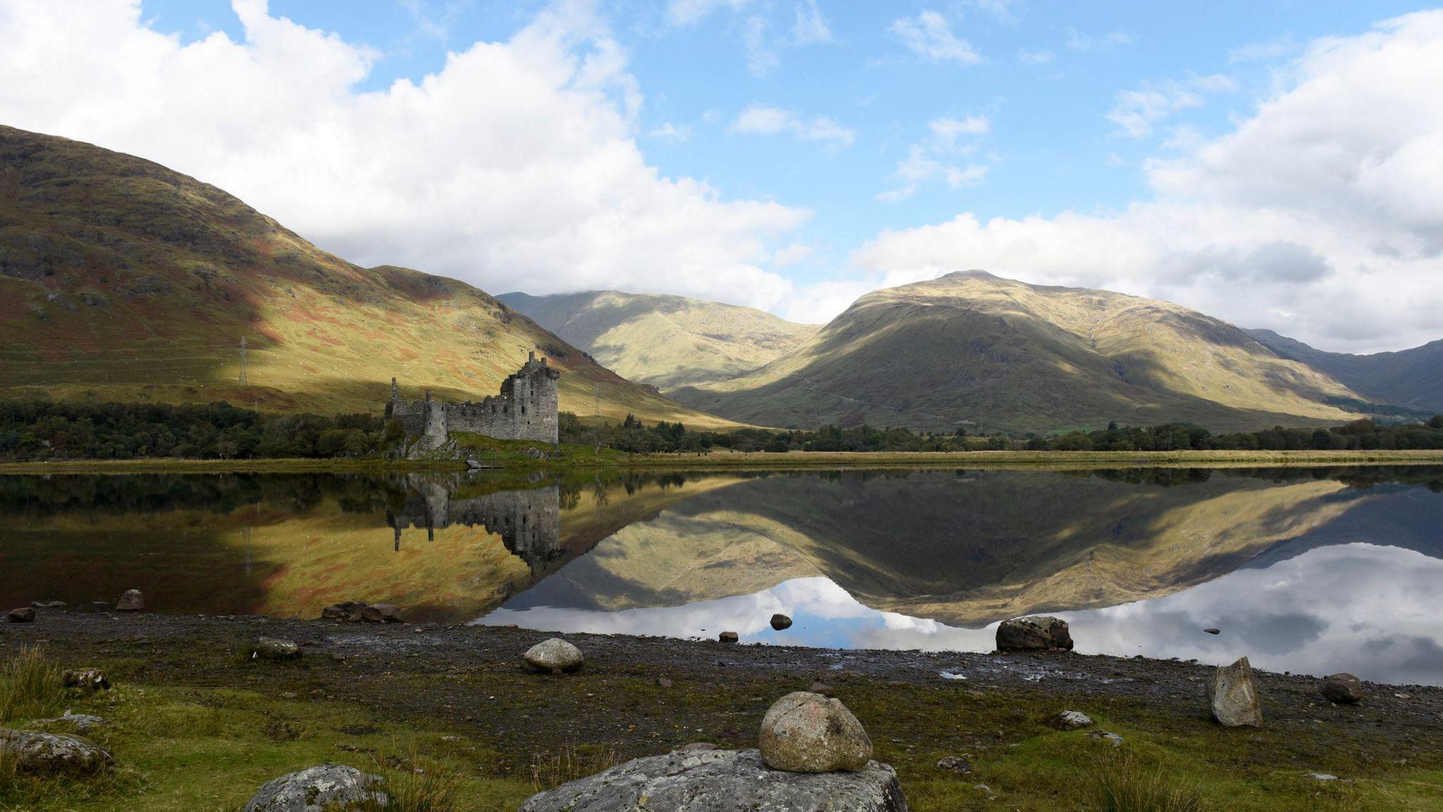 Caisteal Chaol a' Chùirn air Loch Abha le beanntan Ghlinn Urchaidh air a chùlaibh
