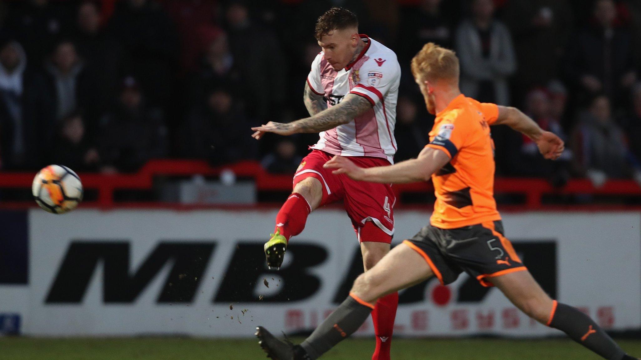 Jack King volleys the ball towards goal under pressure from Reading defender Paul McShane