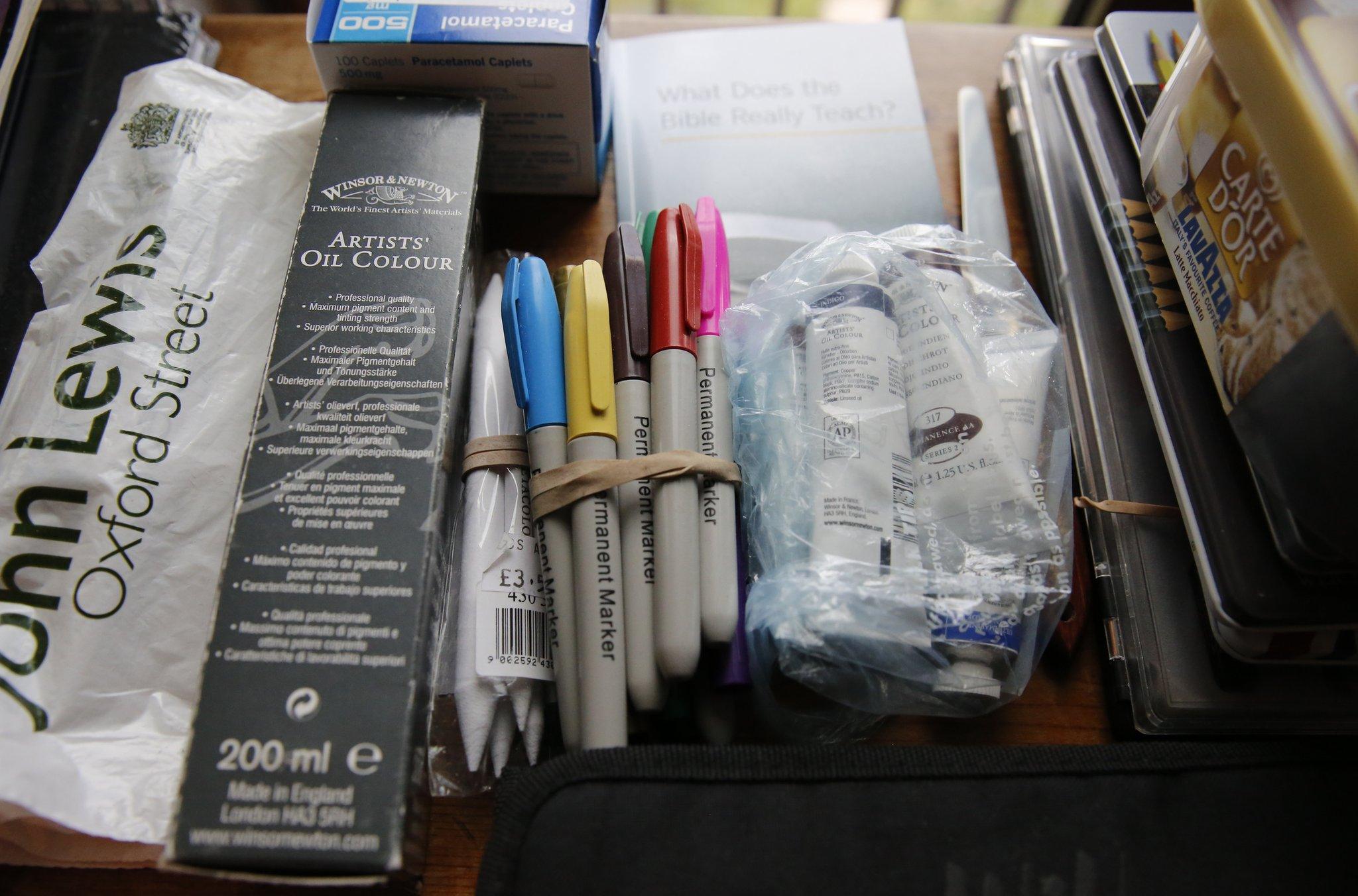 Art equipment lies on a dining room table