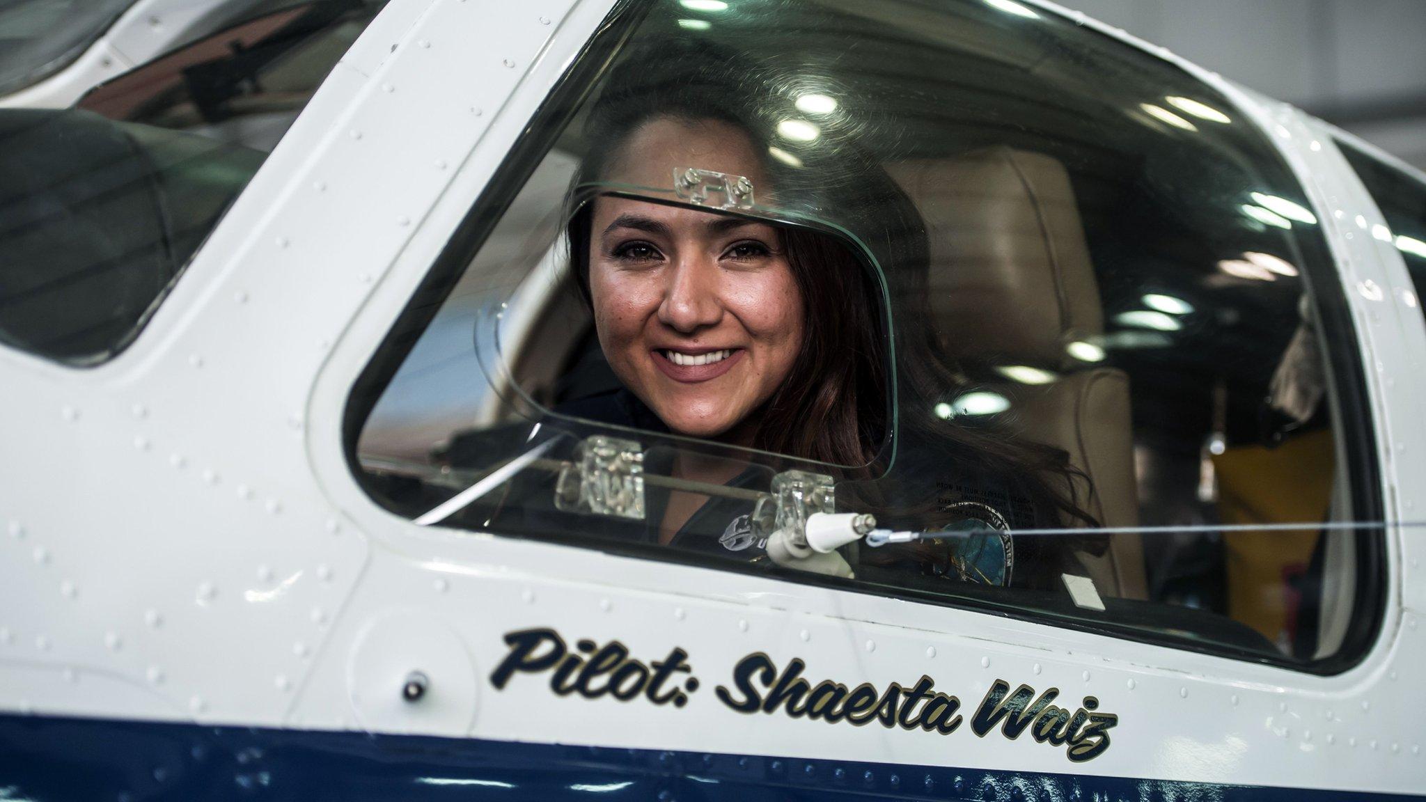 Shaesta Waiz, Afghanistan's first female certified civilian pilot, poses for a picture from inside her plane at Cairo International Airport on July 2, 2017