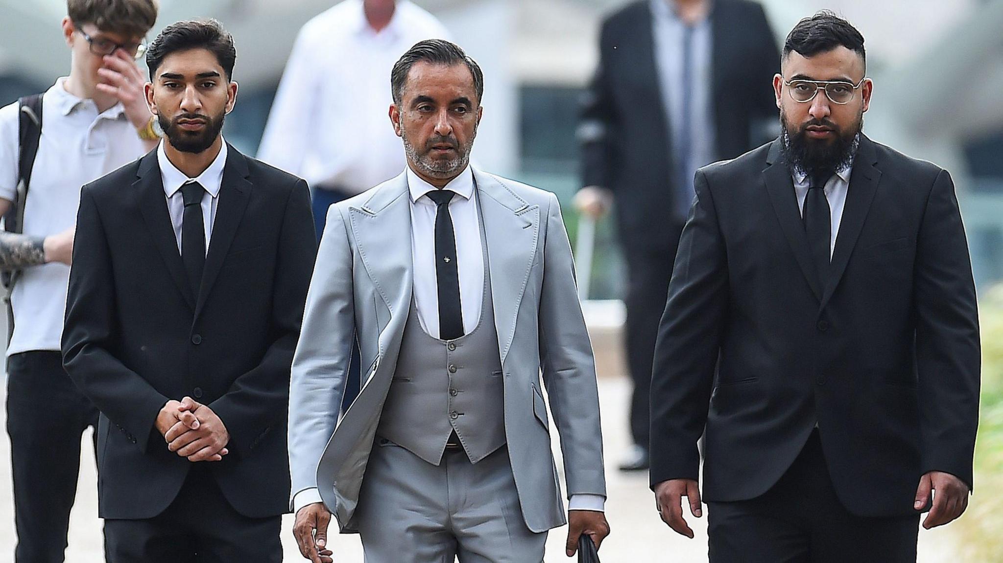 Human Rights lawyer Aamer Anwar (centre) arrives with Mohammed Fahir Amaaz (left) and Muhammed Amaad (right) at Liverpool Crown Court, where they are charged in relation to an altercation with police officers at Manchester Airport's Terminal Two on July 23 2024.