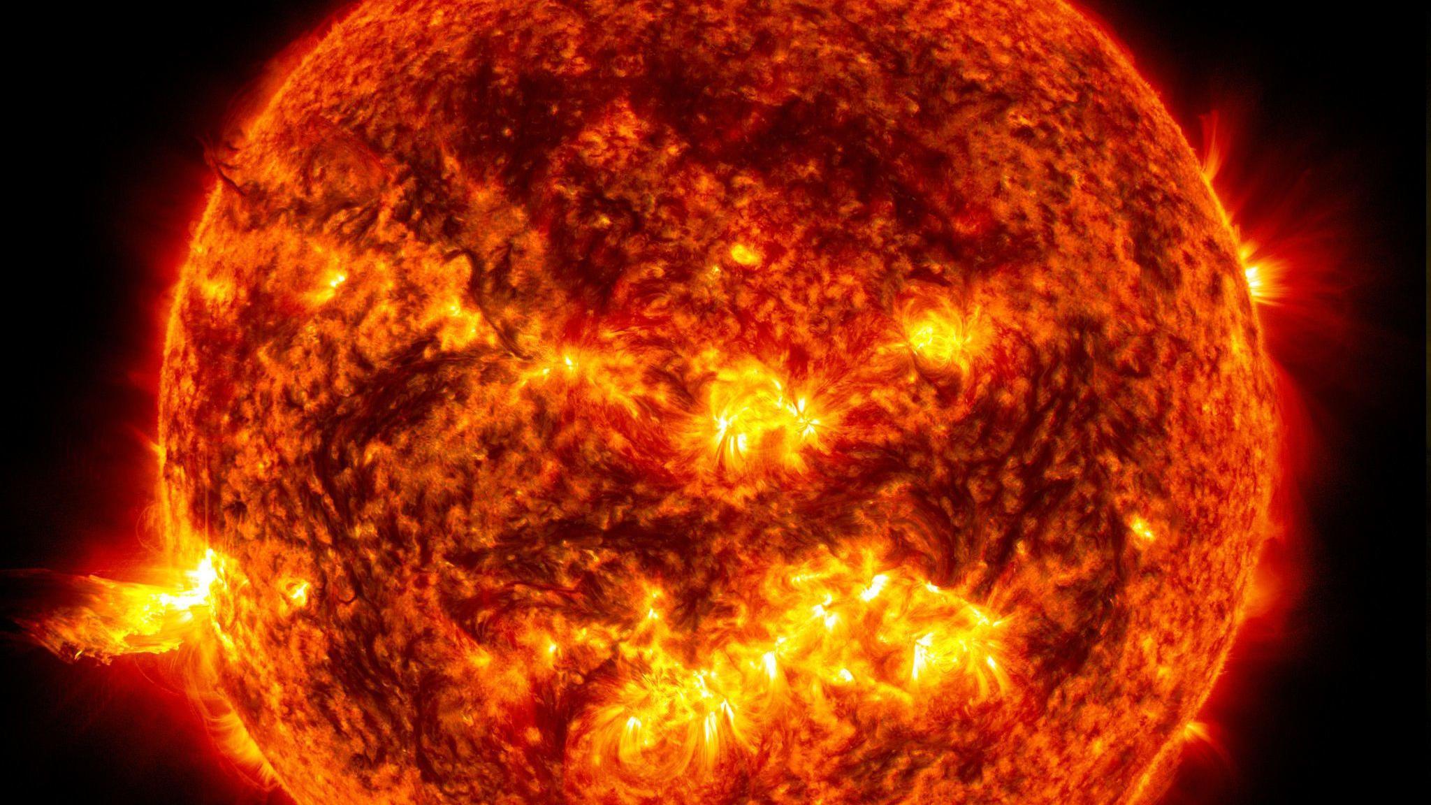 Close up image of the orange Sun with yellow protrusions including a big one on left hand side.