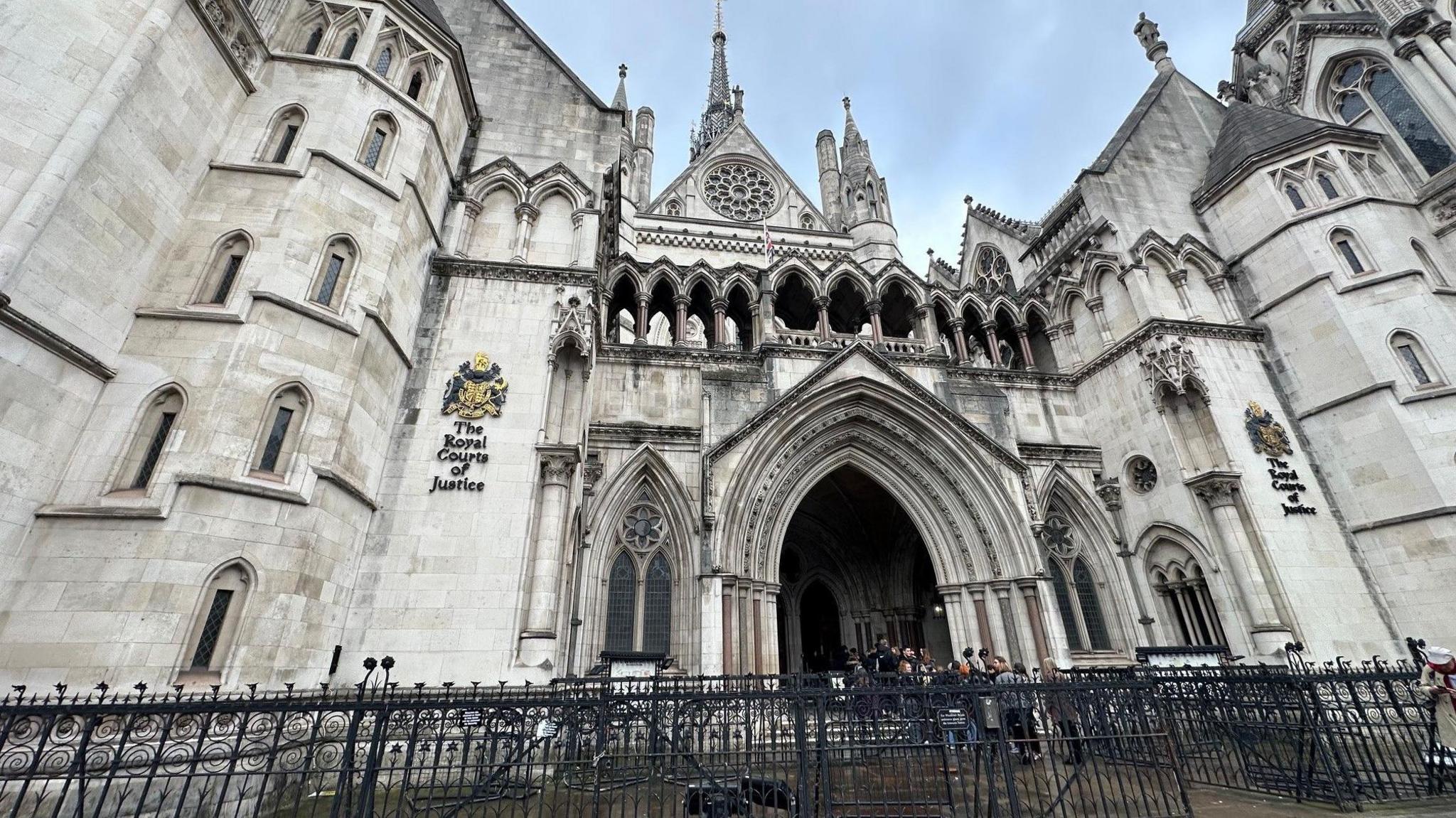 An impressive court building, gothic of white stone with arhced windows and turrets