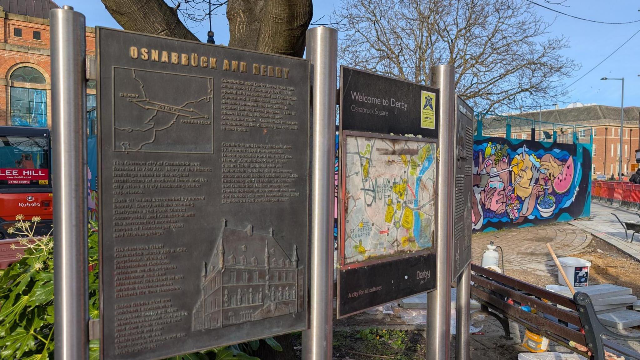 A permanent sign outside Derby Market Hall, with information about the connection between Osnabruck, in Germany, and Derby 