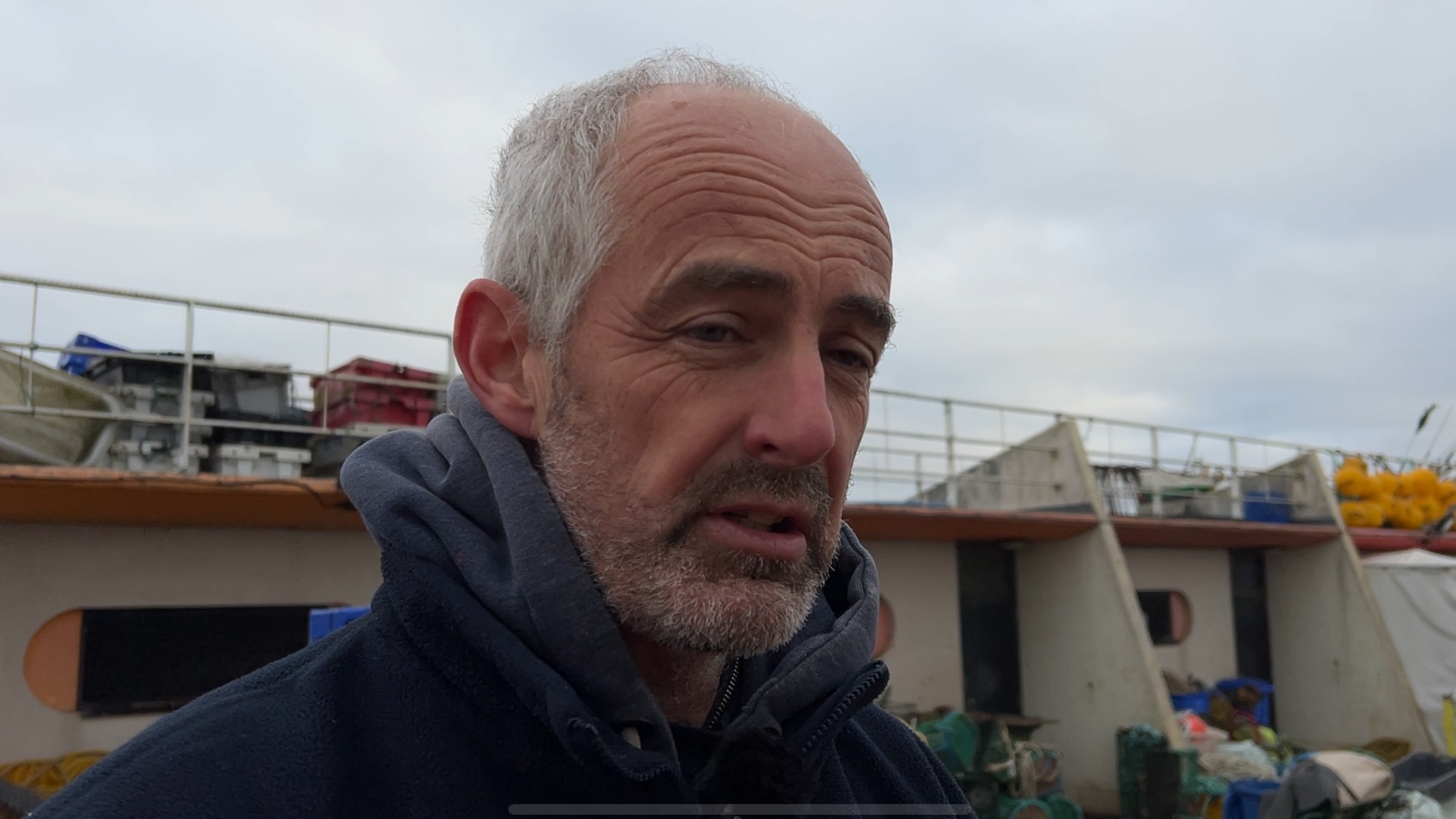 Andy Faichney's boat was recently damaged by huge boulders hidden just below the water on the beach. He believes boats dredging offshore for building materials are dumping unusable aggregates and winter storms are washing it onto the beach.