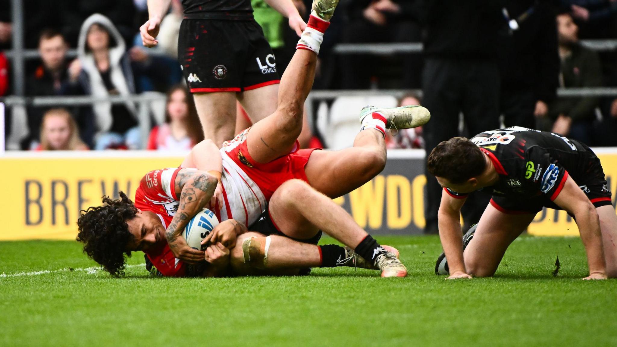 Tristan Sailor scores for St Helens late on against Wigan Warriors