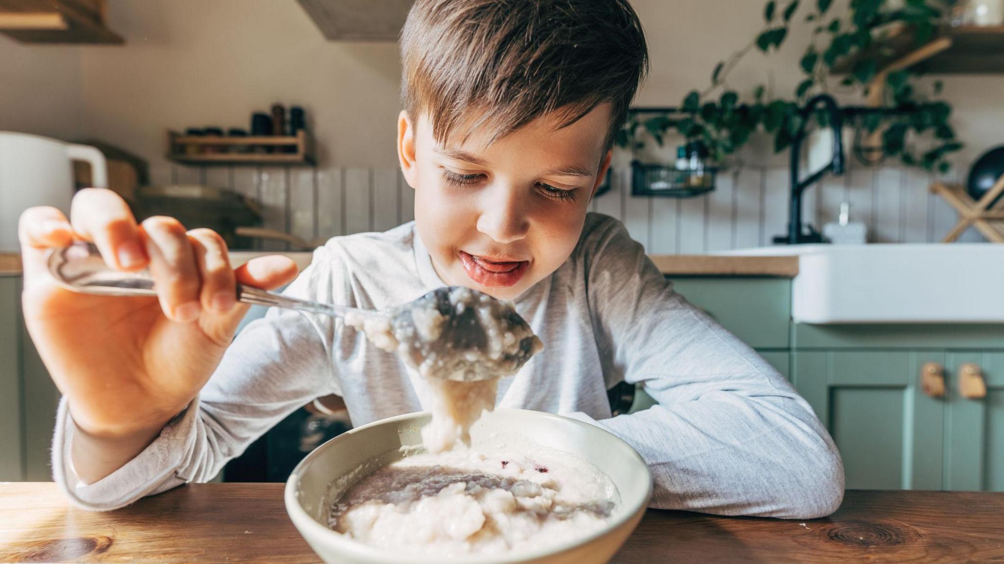 Boy eating porridge 