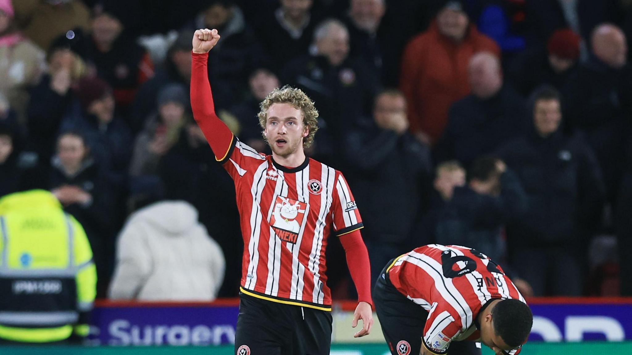 Tom Davies with his arm aloft in celebration after scoring for Sheffield United