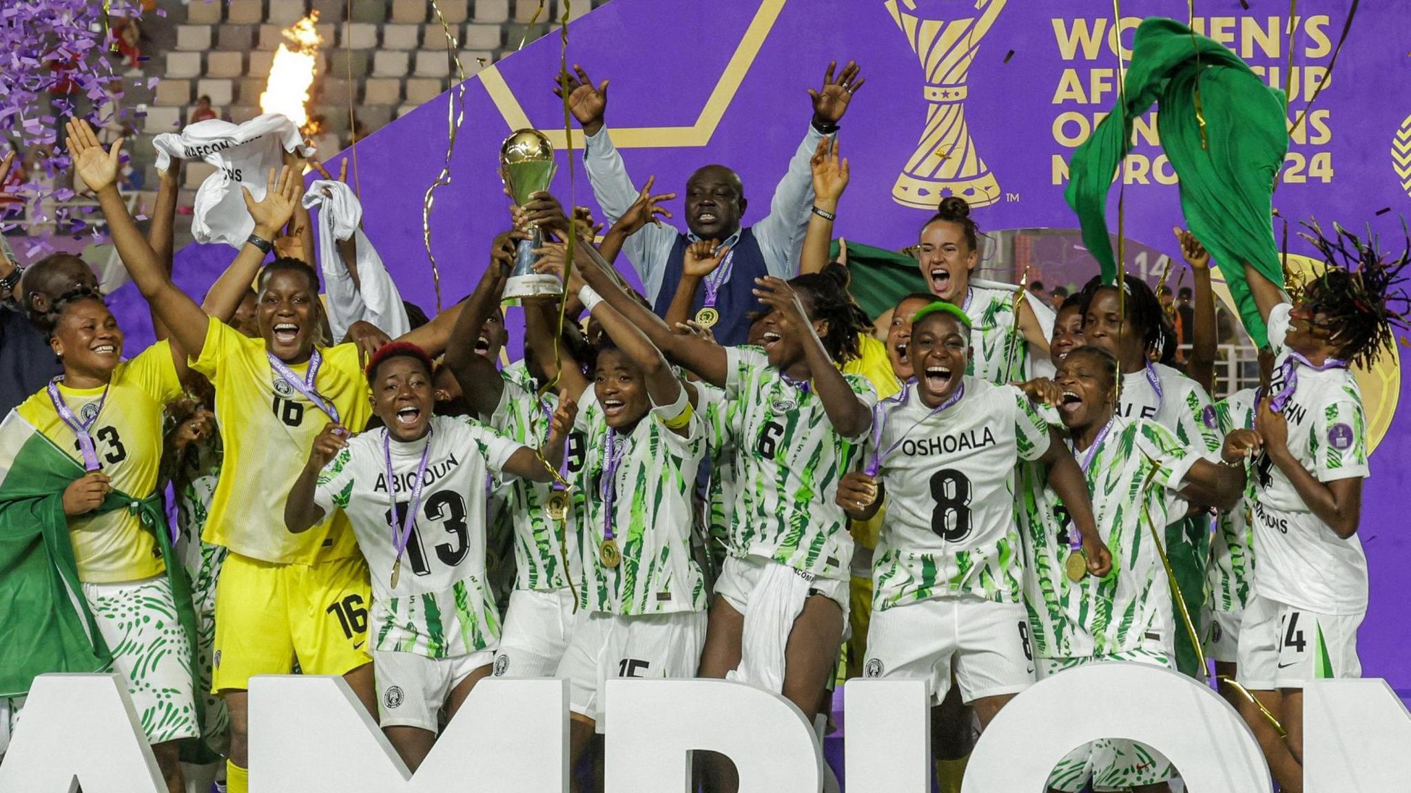 A large group of Nigerian players celebrate as they lift the Women's Africa Cup of Nations trophy