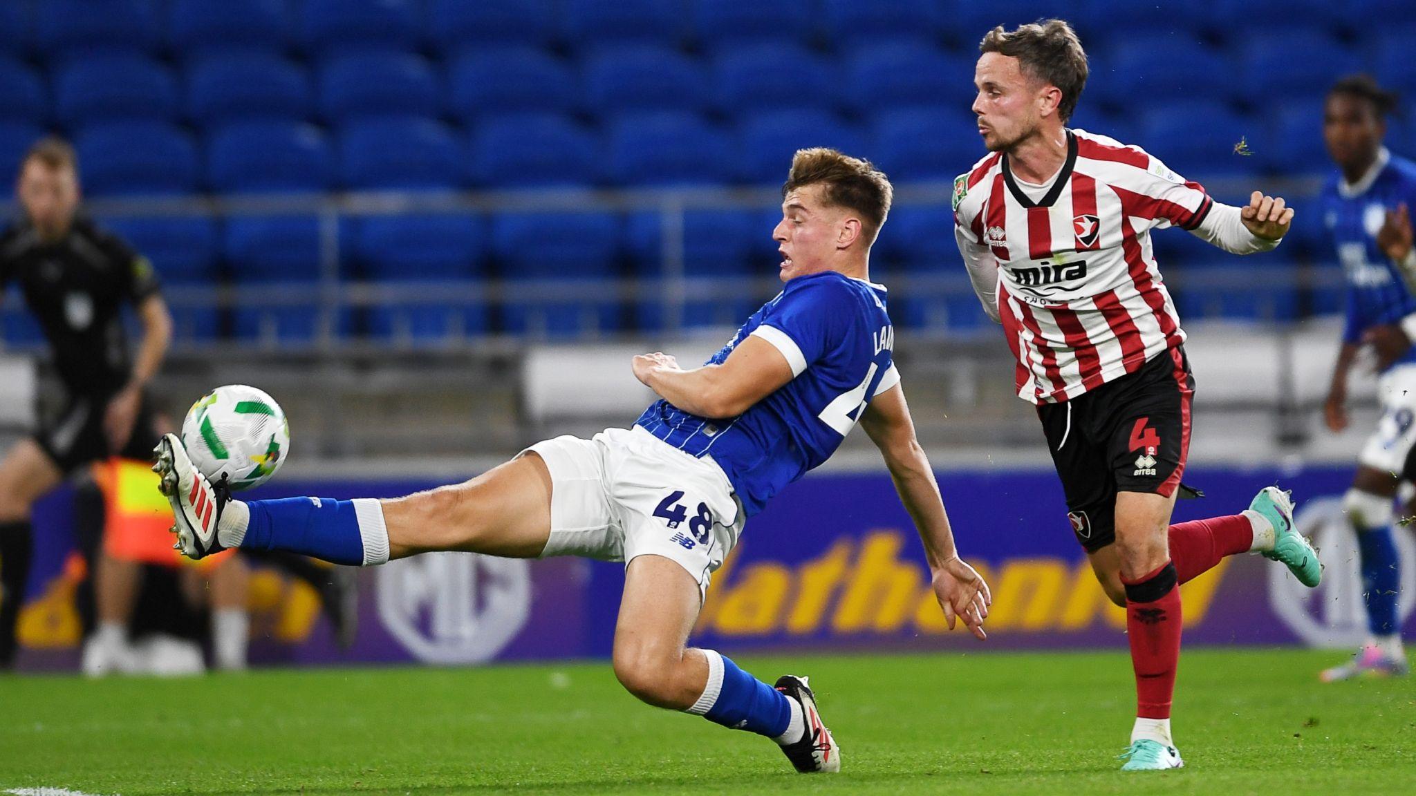 Dylan Lawlor of Cardiff City is challenged by Liam Kinsella of Cheltenham Town