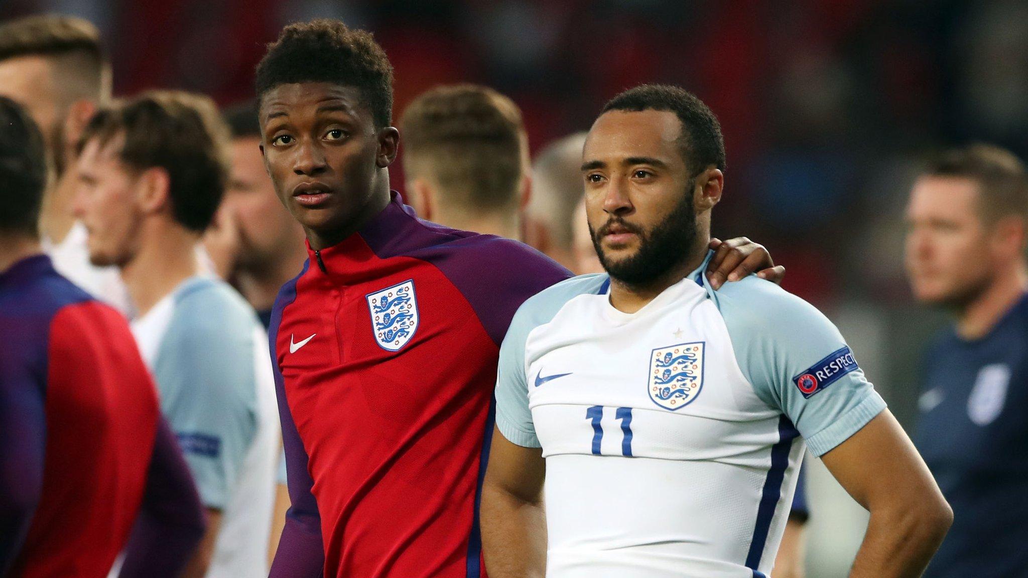 England players look on in sadness after losing to Germany on penalties