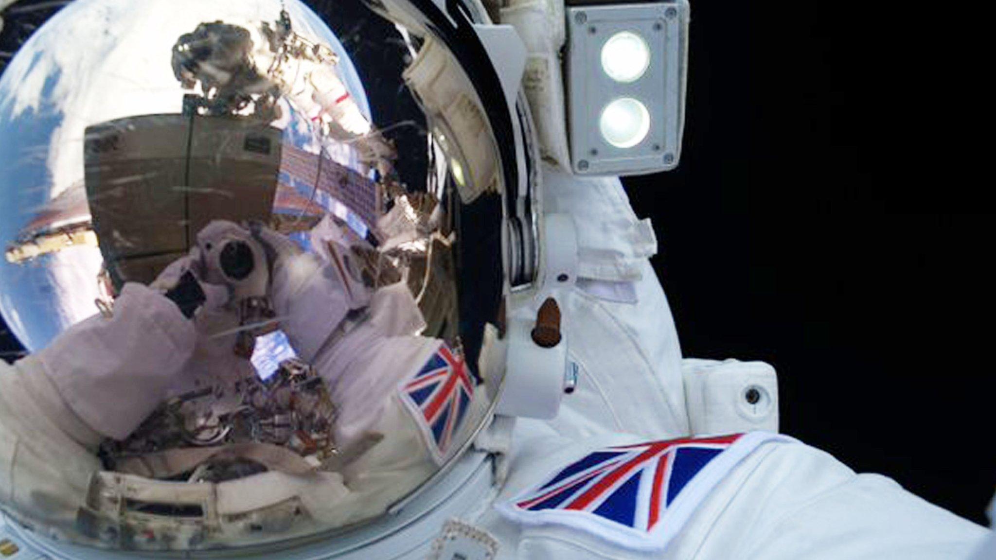 Tim Peake's helmet reflecting a view of Earth