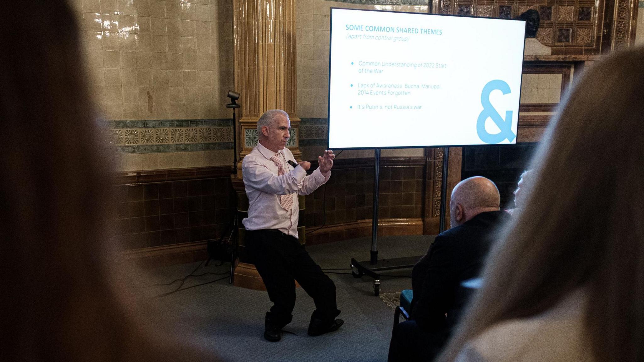 Steven Lacey standing in front of a presentation screen. He is presenting to an audience