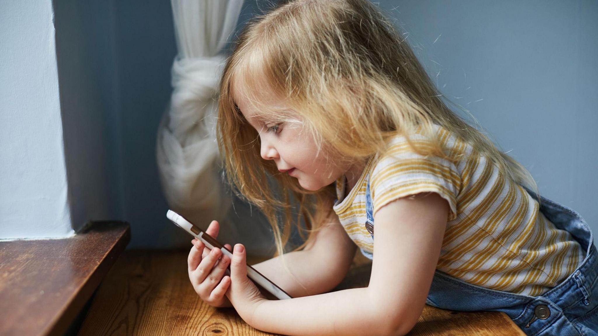 Child looking at phone.