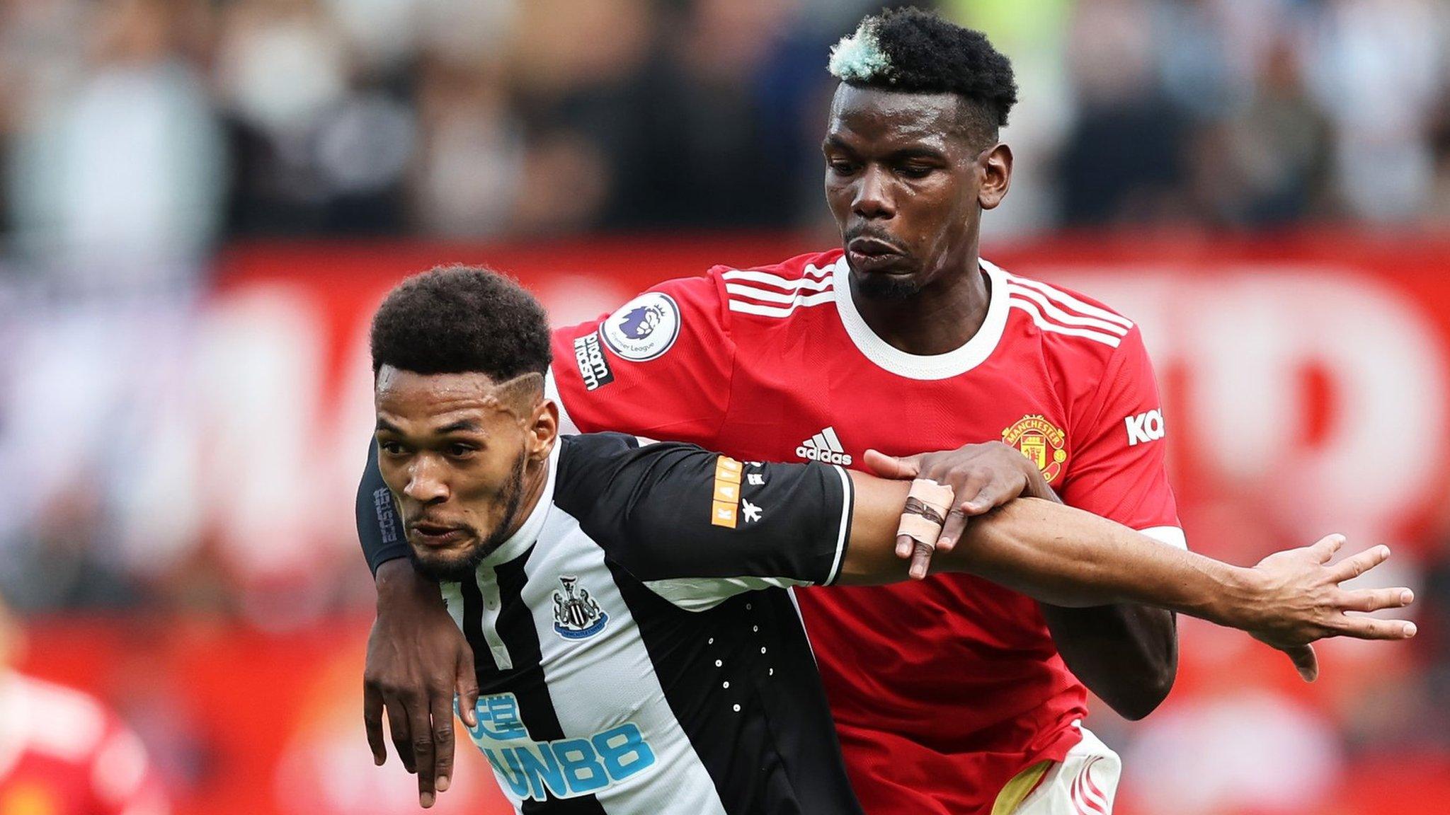 Manchester United's Paul Pogba and Newcastle's Joelinton fight for the ball