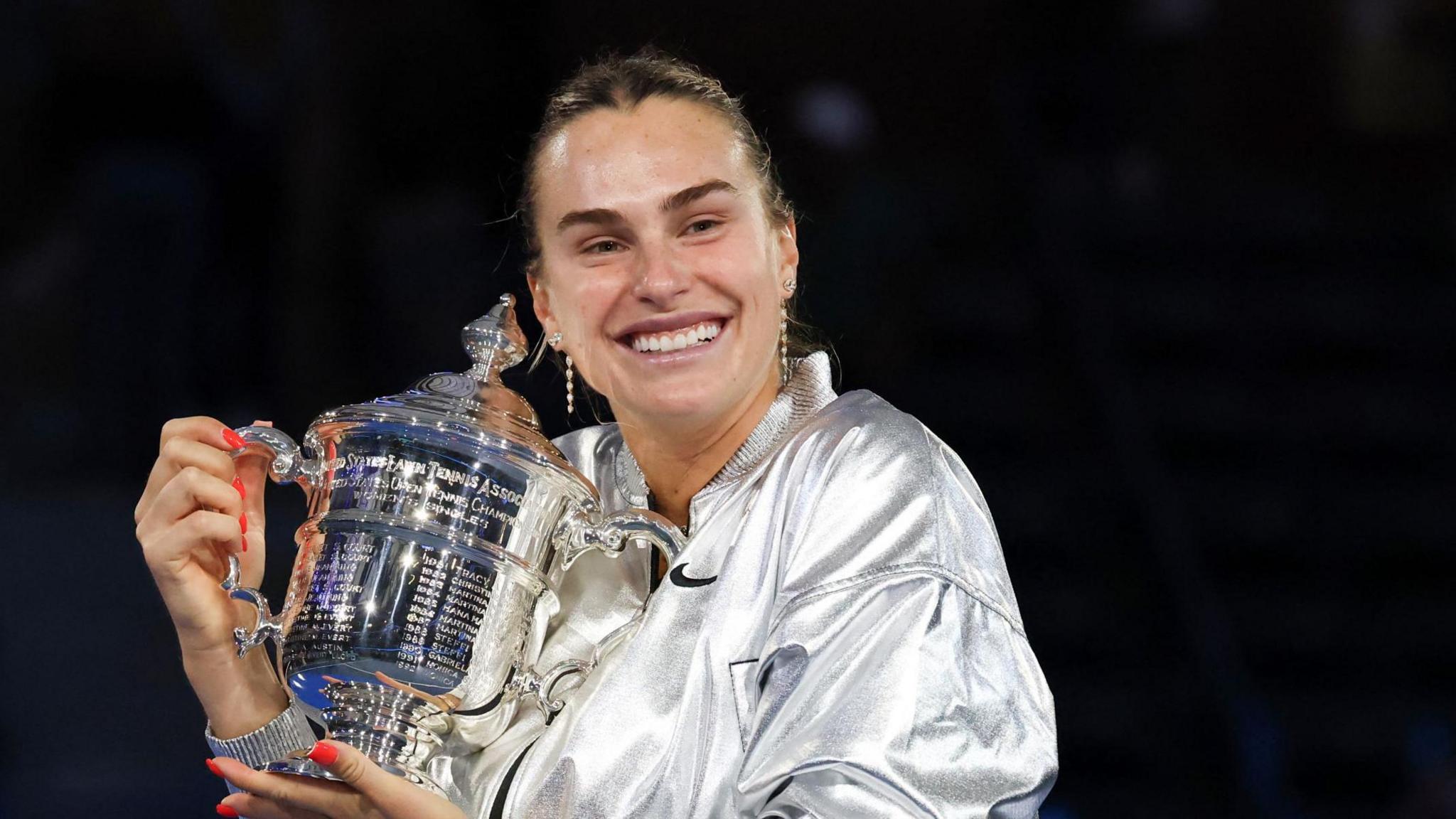 Aryna Sabalenka cradles the US Open trophy