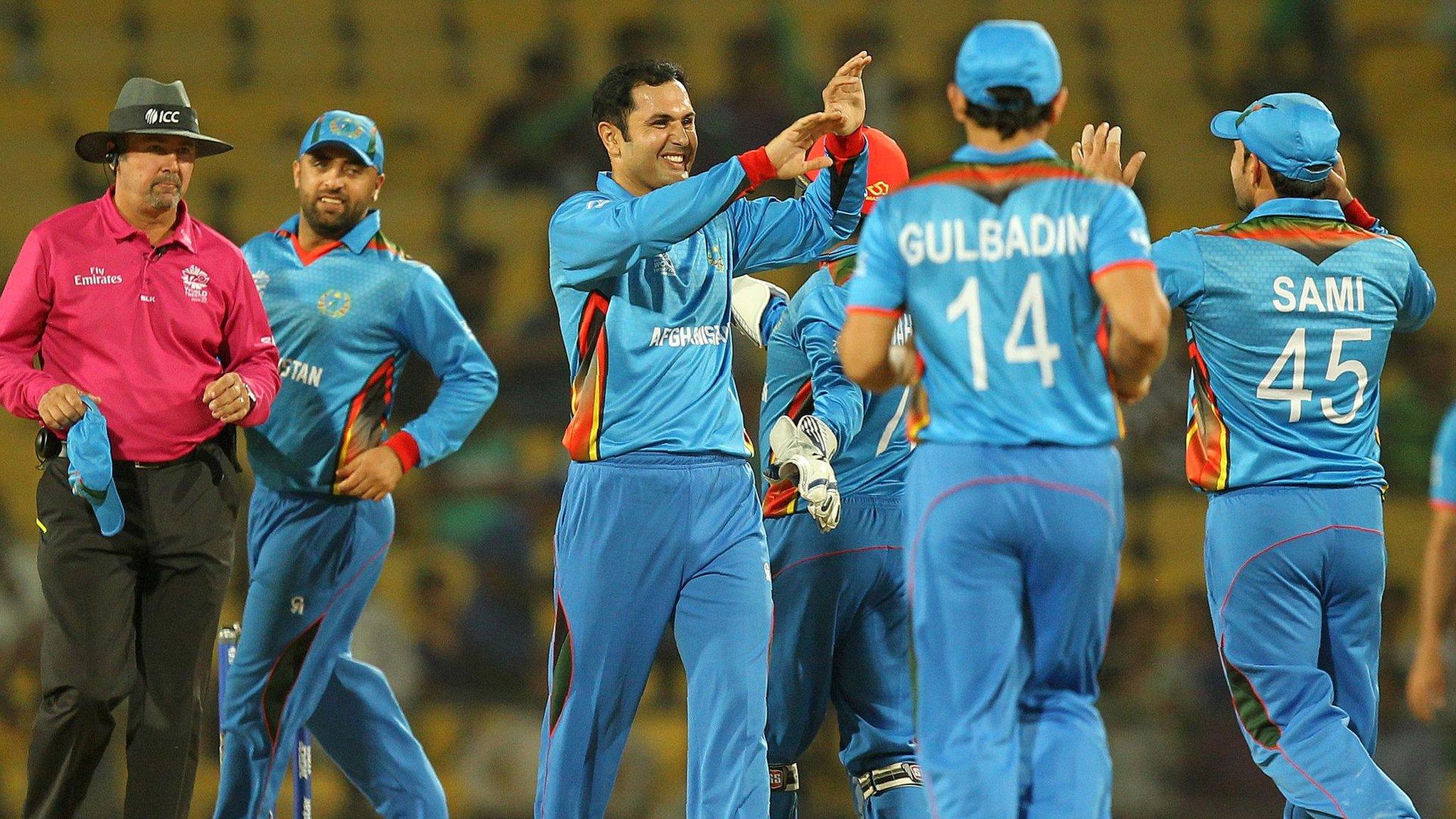 Afghanistan celebrate a wicket by Mohammad Nabi (centre)