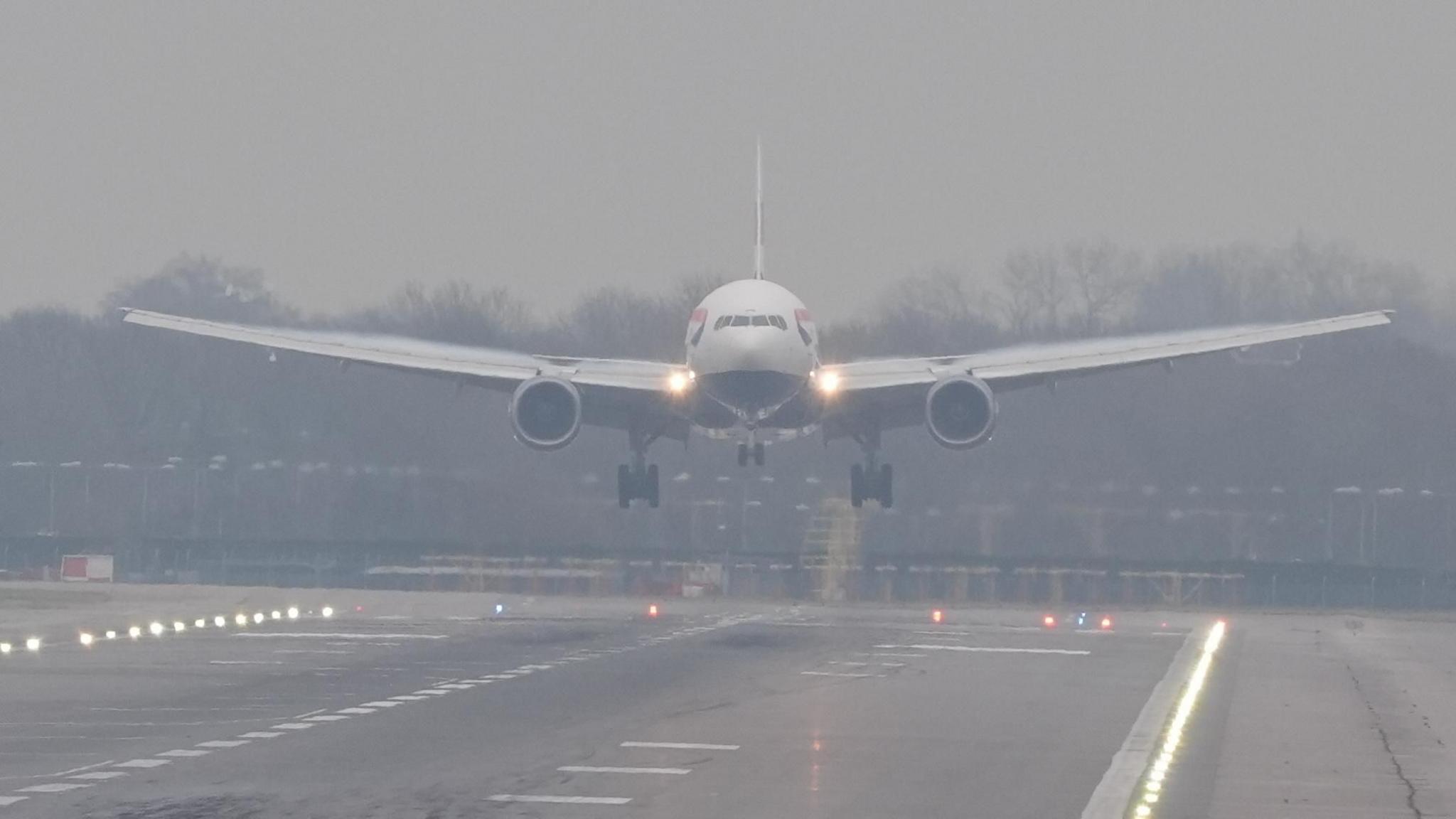 A plane lands in misty conditions from London Gatwick airport in Crawley, West Sussex.