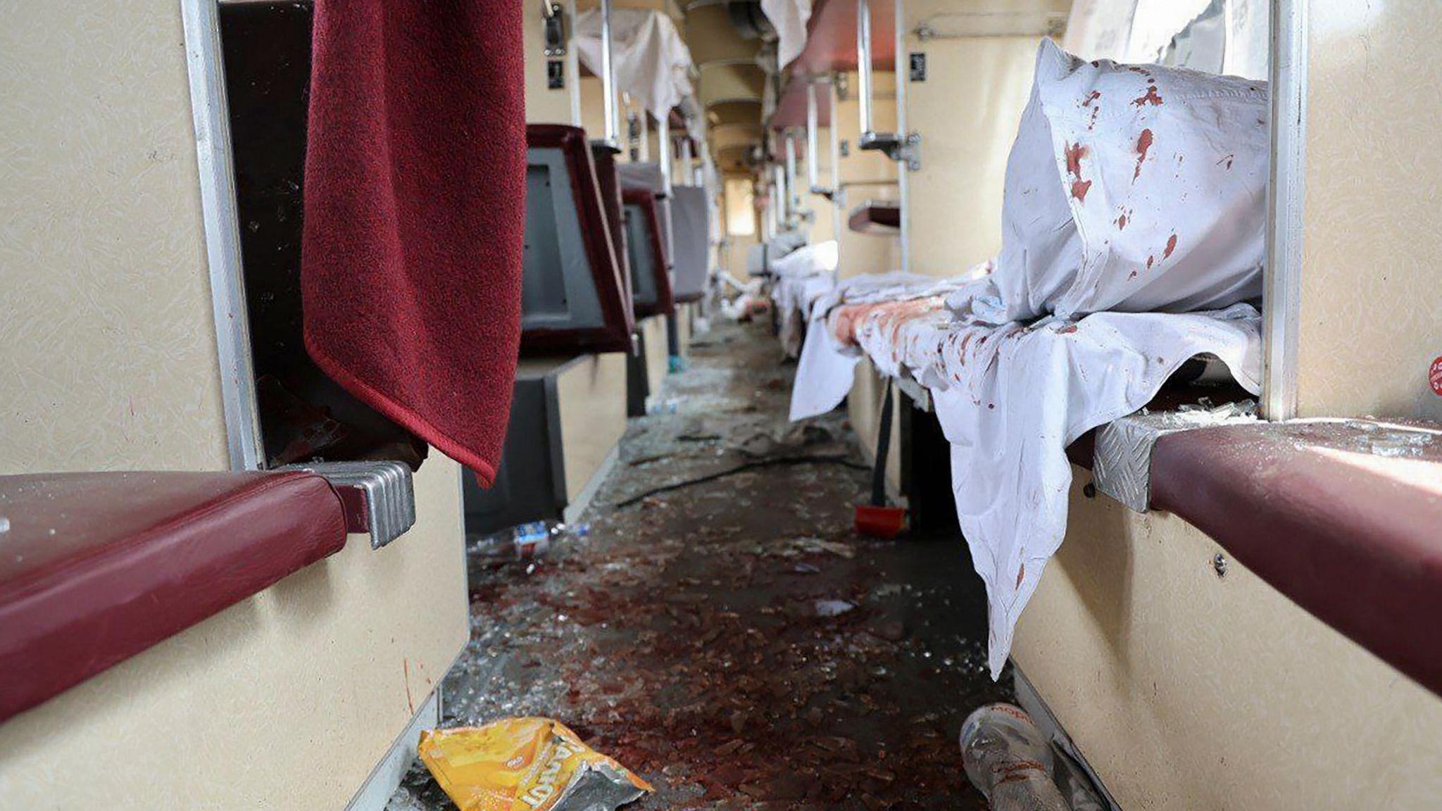 Blood and glass lie on the floor of a passenger train damaged in a Russian attack near the city of Dnipro, 24 June 2025