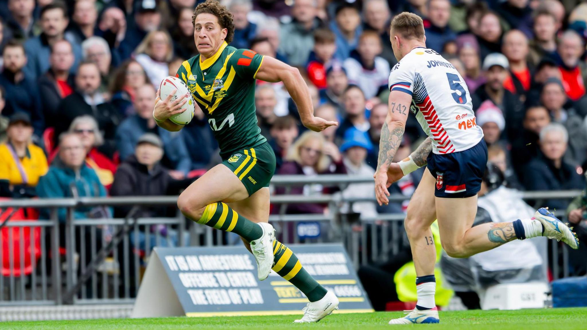 Mark Nawaqanitawase looks to take England's Tom Johnstone on for pace down the right wing on Australia debut