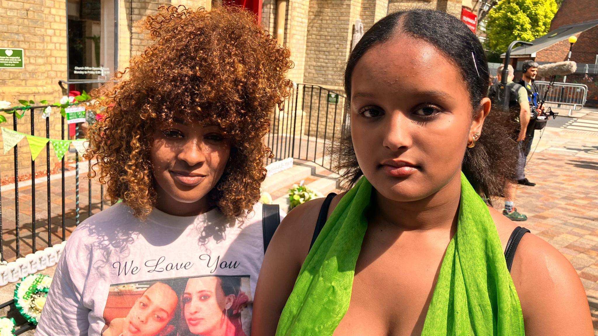 Hemen, who is wearing a green scarf, is pictured with another aunt looking at the camera.