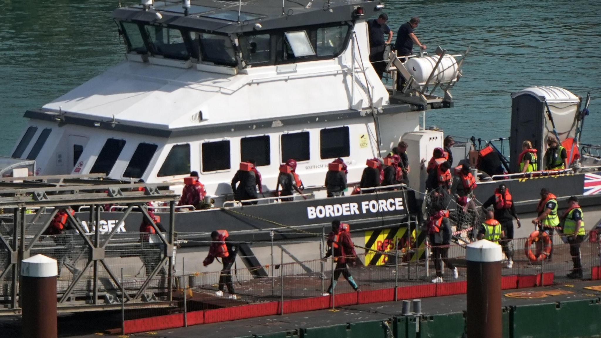 A group of people thought to be migrants are brought in to the Border Force compound in Dover, Kent.