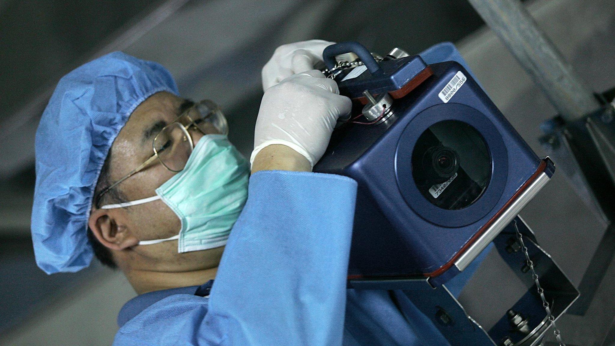 File photo shows an IAEA inspector installing a surveillance camera at the Isfahan Uranium Conversion Facilities (UCF) in Iran (8 August 2005)