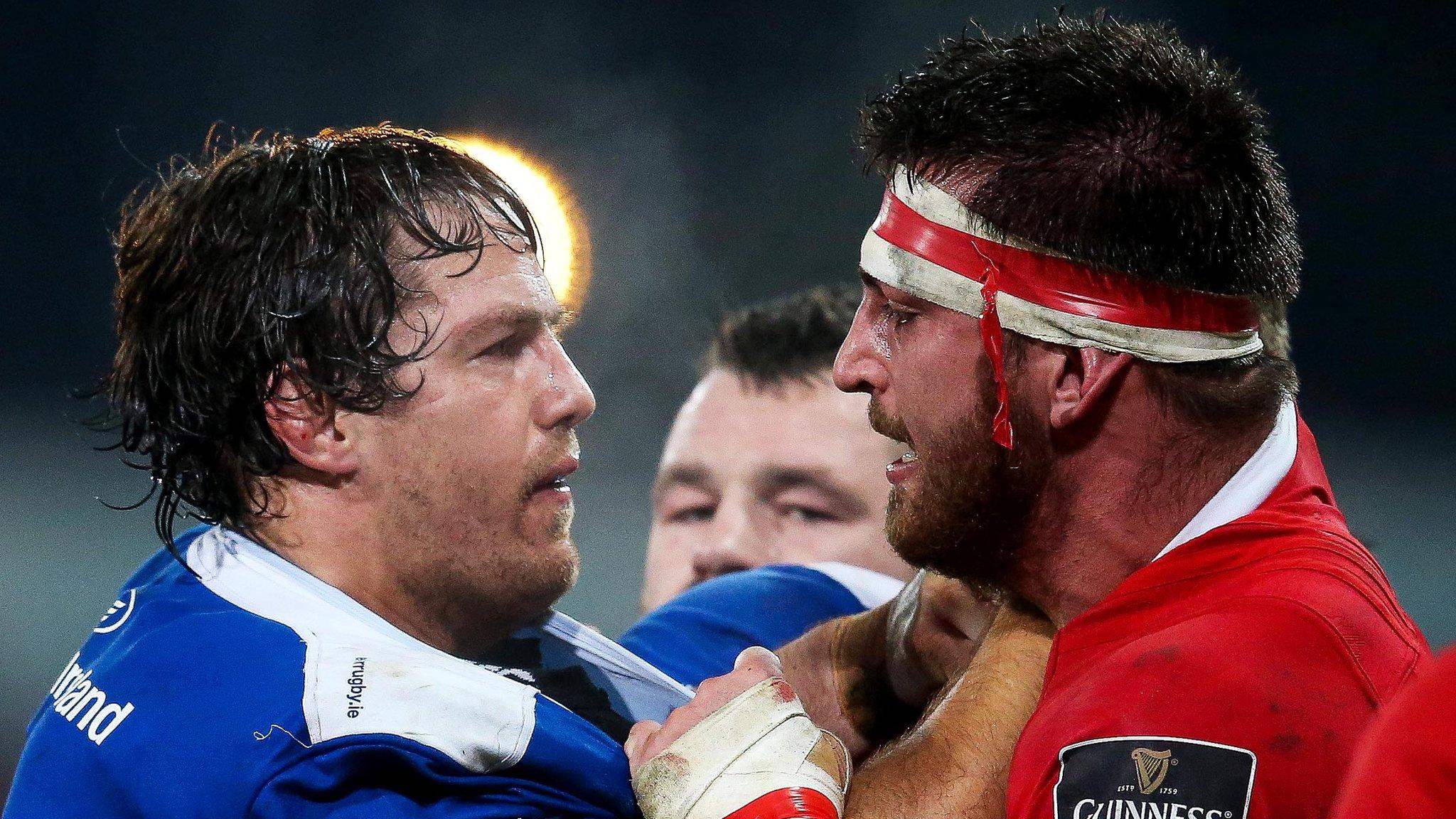 Leinster lock Mike McCarthy tangles with opposite number Jean Kleyn at a packed Thomond Park