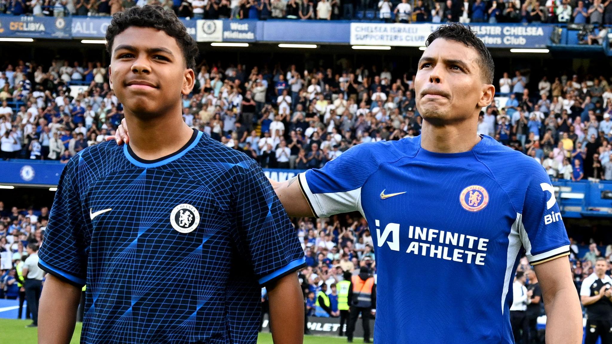 Thiago Silva of Chelsea shows appreciation to the fans with son Isago Silva at full-time after his final appearance