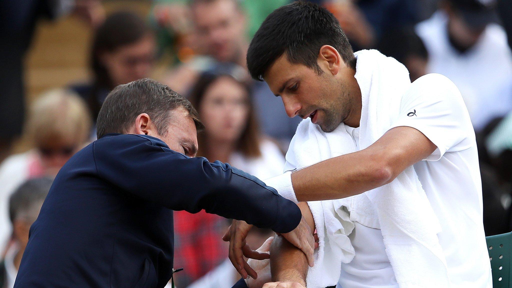 Novak Djokovic gets treatment during Wimbledon