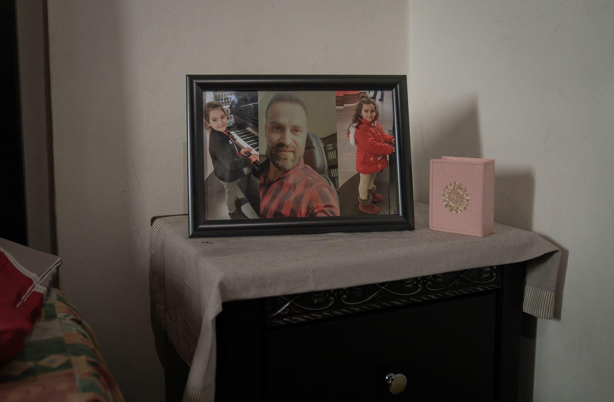 A picture of Rihab’s husband Saeed and their two girls Naya and Tia sits on her bedside table. (Joel Gunter/BBC)