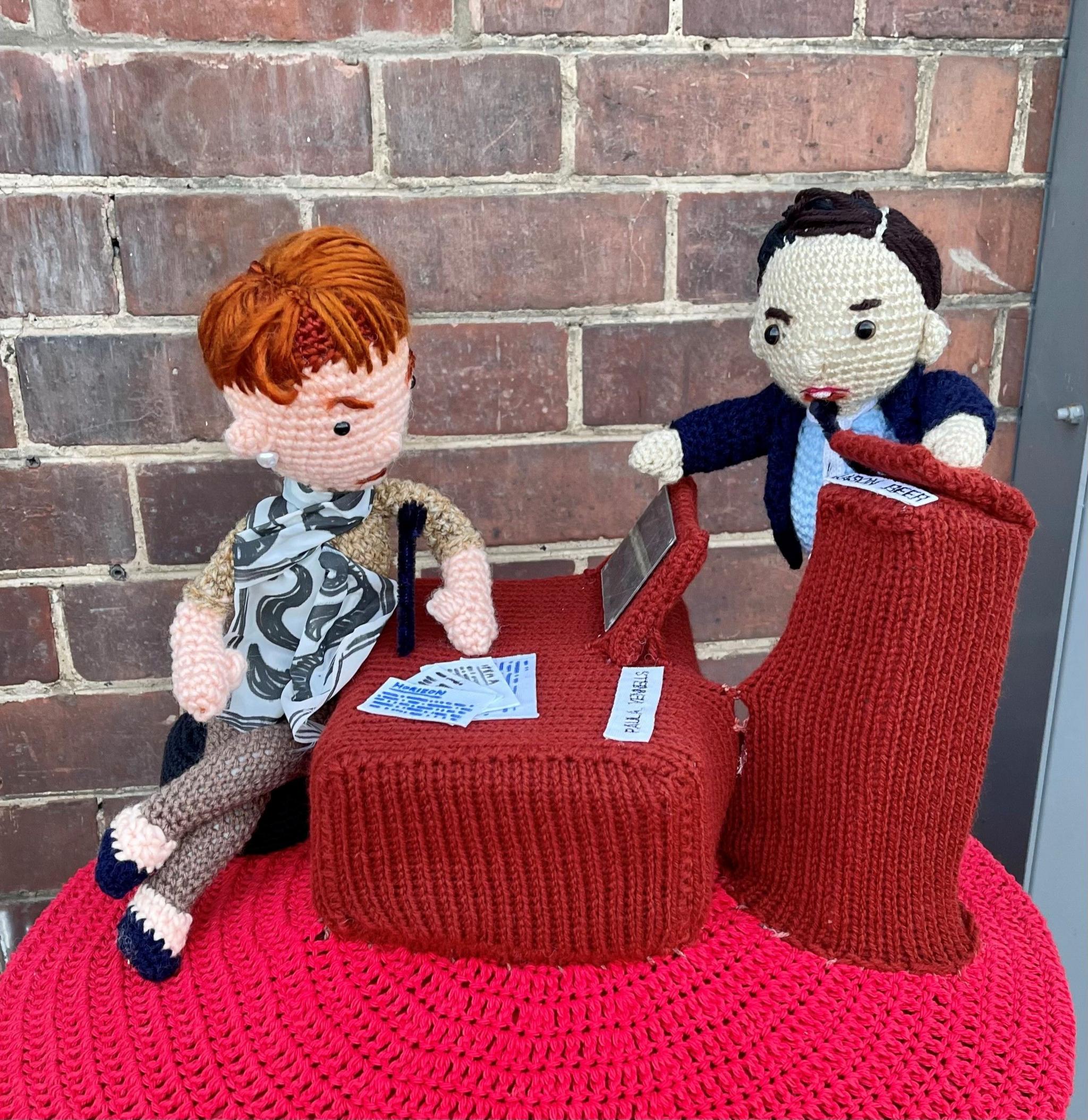 Abi Smith's knitted post box topper depicting Jason Beer questioning Paula Vennells at the Post Office inquiry