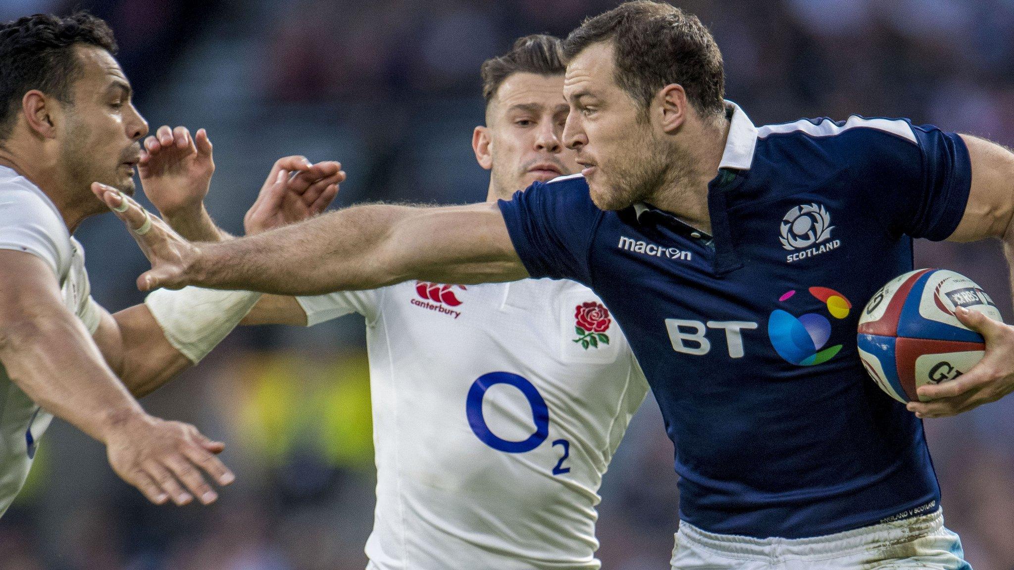 Scotland wing Tim Visser tries to hold off two England tacklers at Twickenham