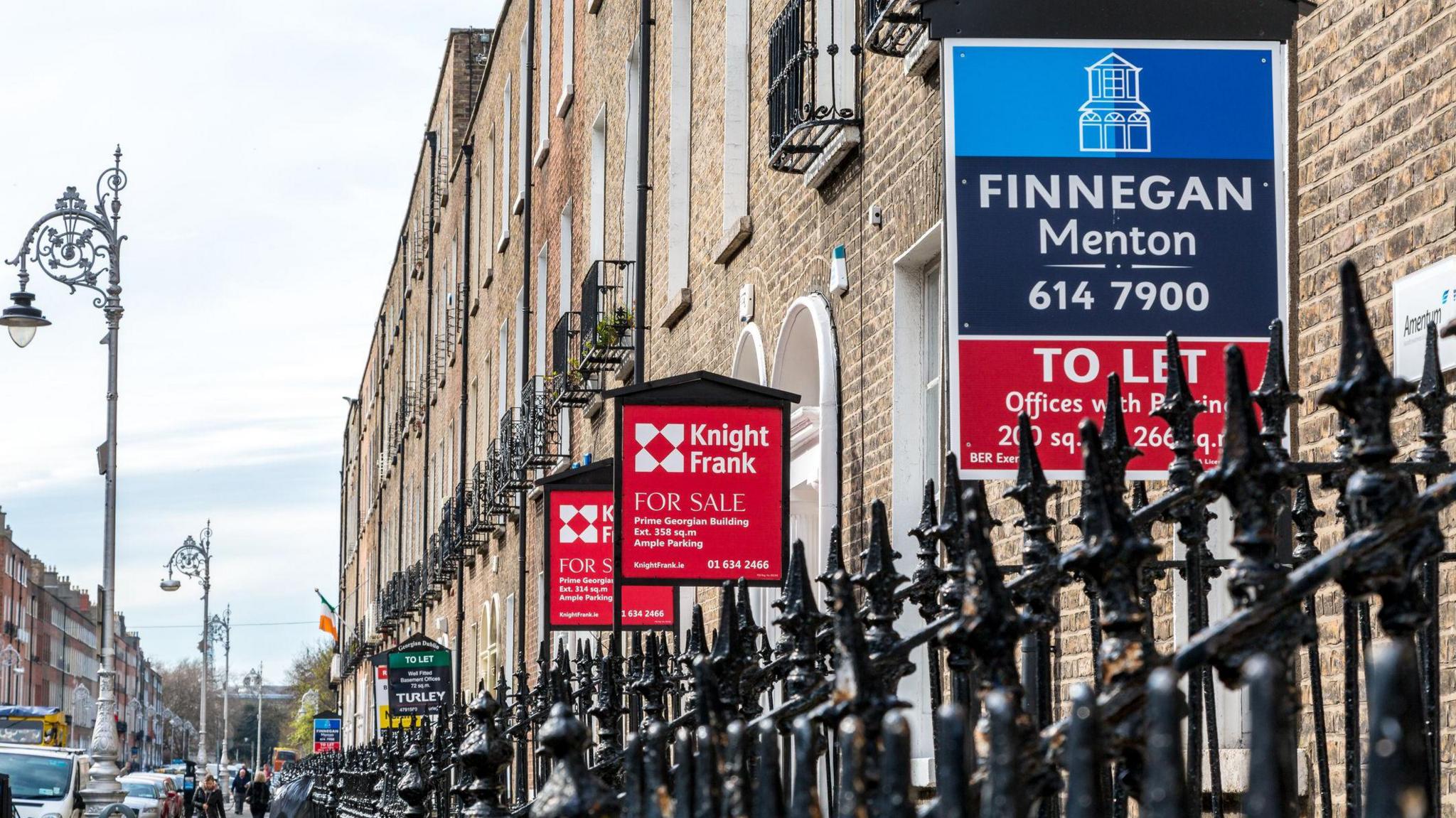  Several brokerage signs in a row outside apartments and offices. They are Georgian buildings in Dublin city centre