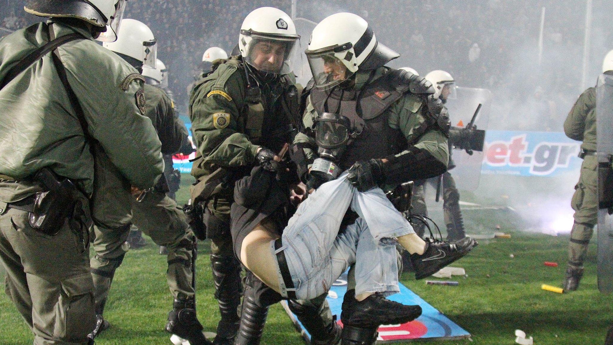 Riot police clash with PAOK fans during their Greek Cup semi-final against Olympiakos