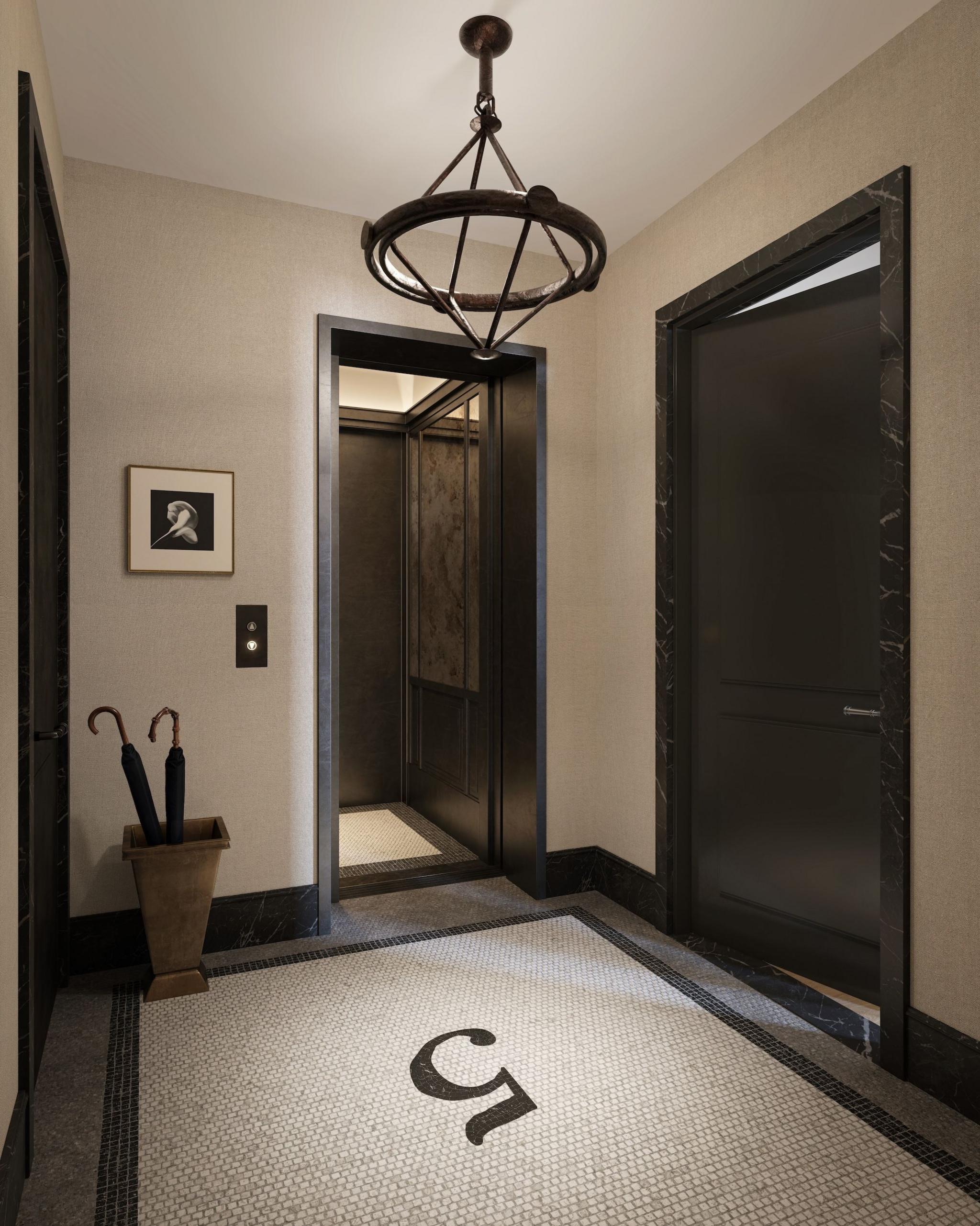 View of hallway entry into a residence, with tiled mosaic on the floor
