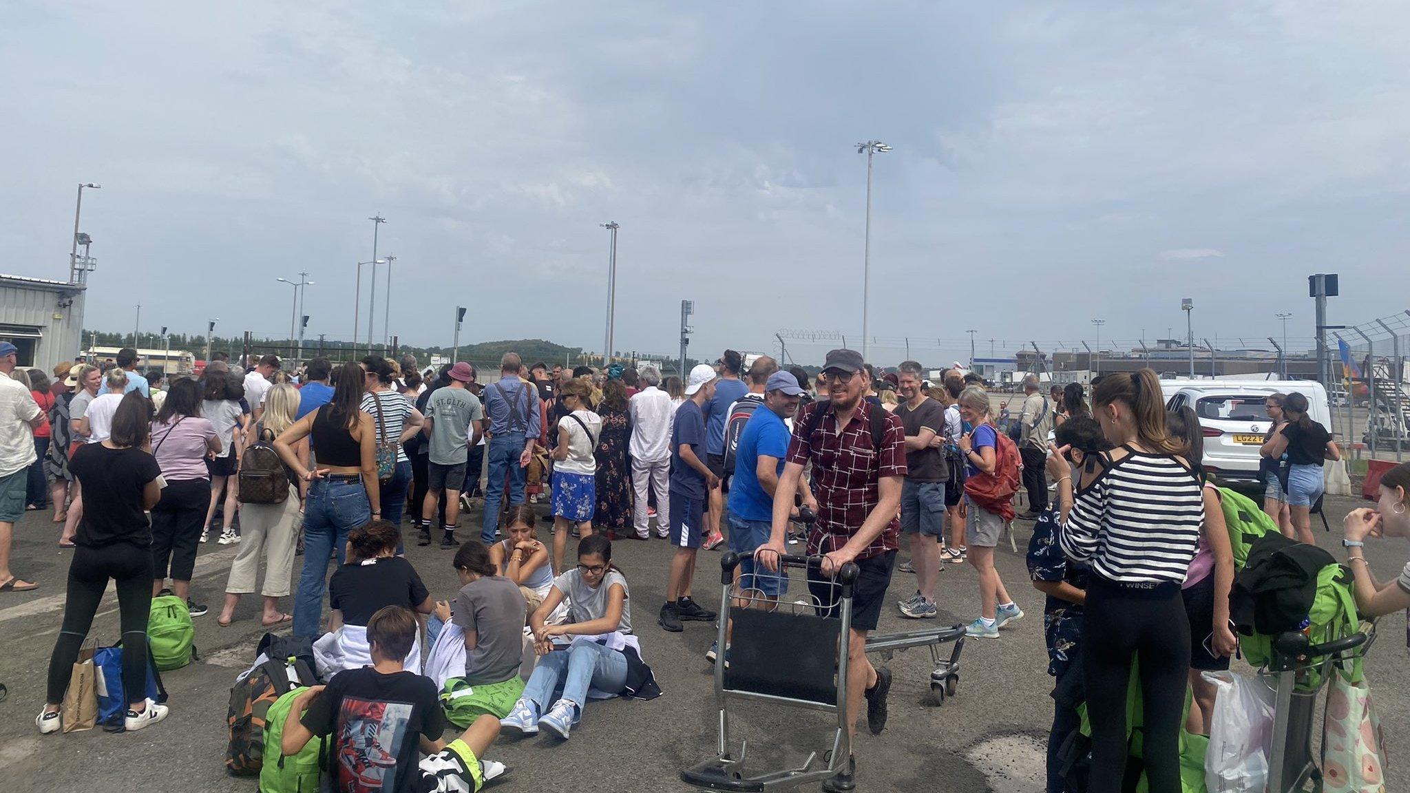 People waiting for luggage outside the airport