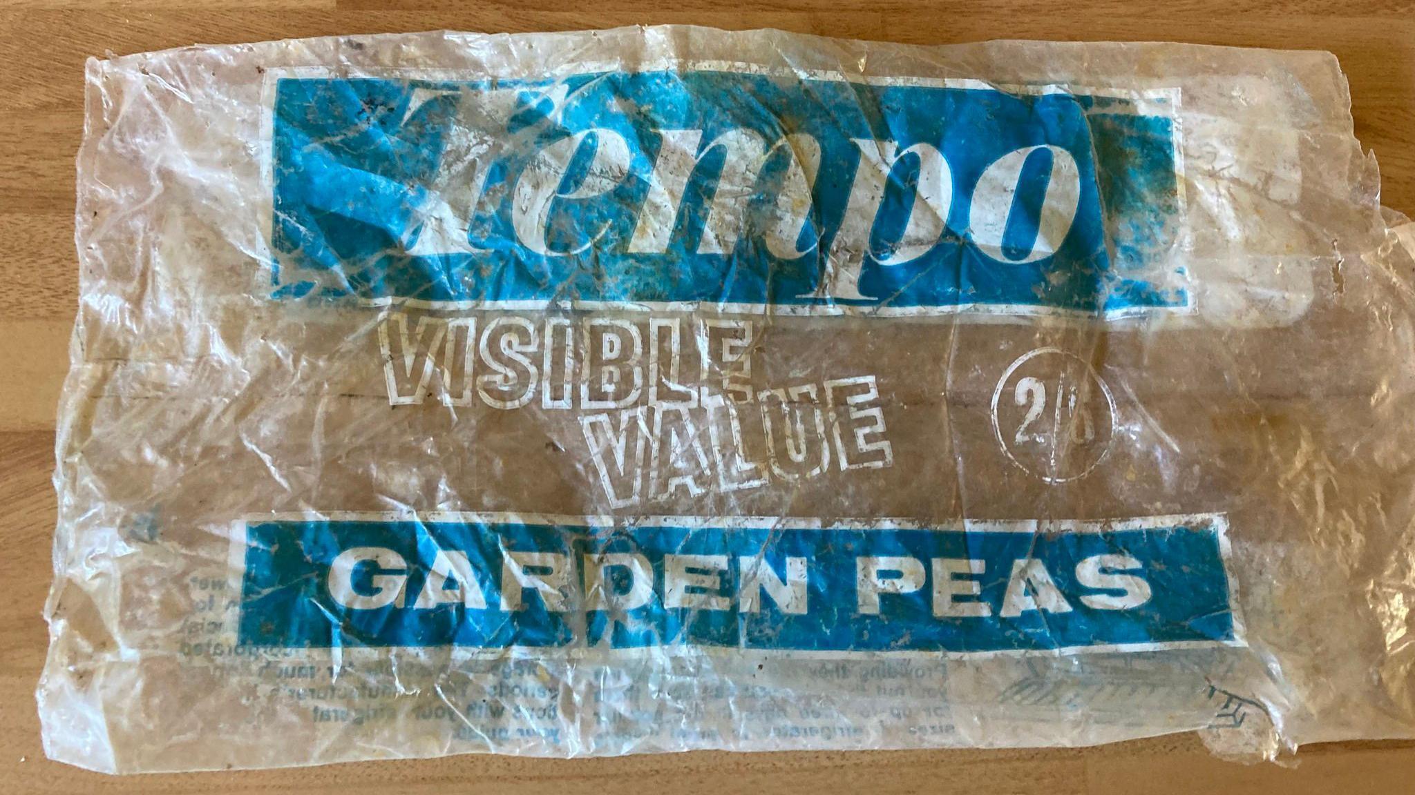 Photograph of an empty Tempo-branded bag of garden peas, with its cost showing 2/8